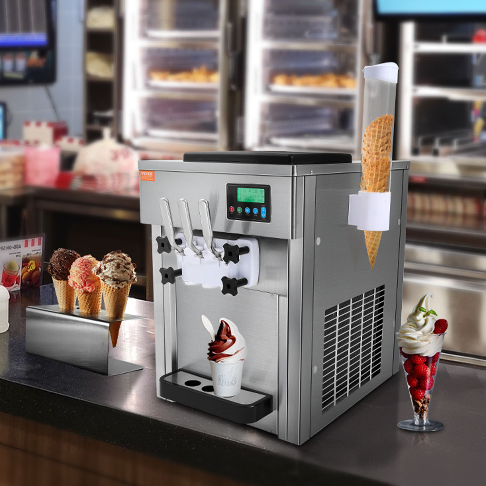 Máquina de helados de acero inoxidable en un mostrador con tres palancas, dispensador de conos y copas.