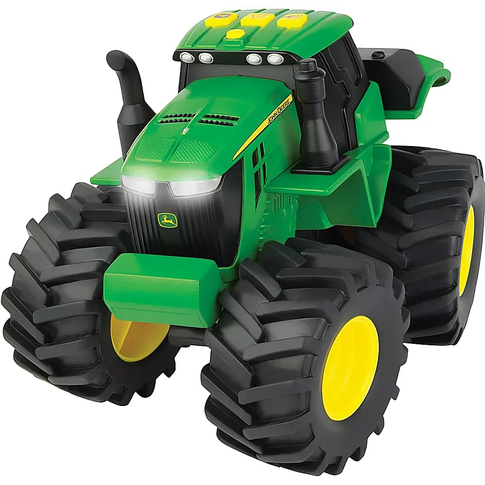 Un tracteur jouet vert avec de grands pneus crantés et des jantes jaunes sur fond blanc.