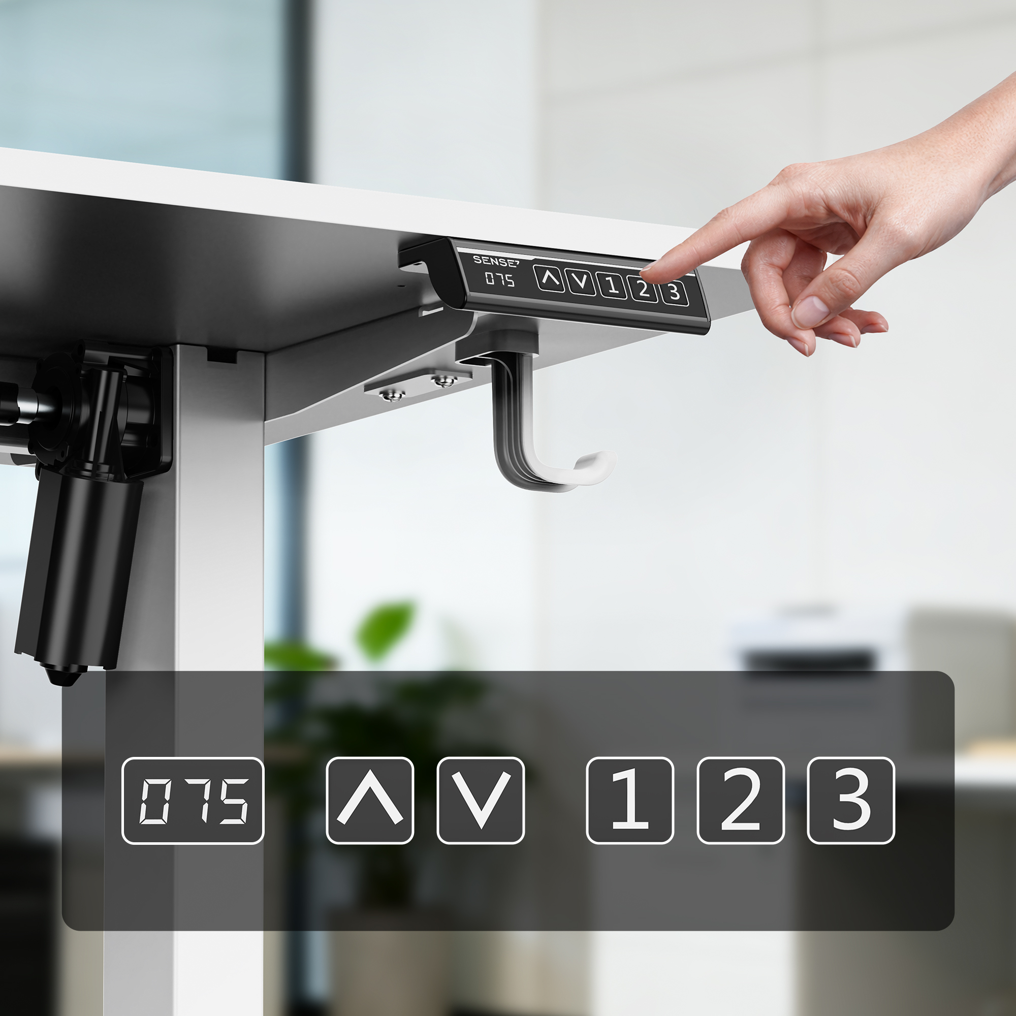 Hand pressing the control button of an electric height-adjustable desk.
