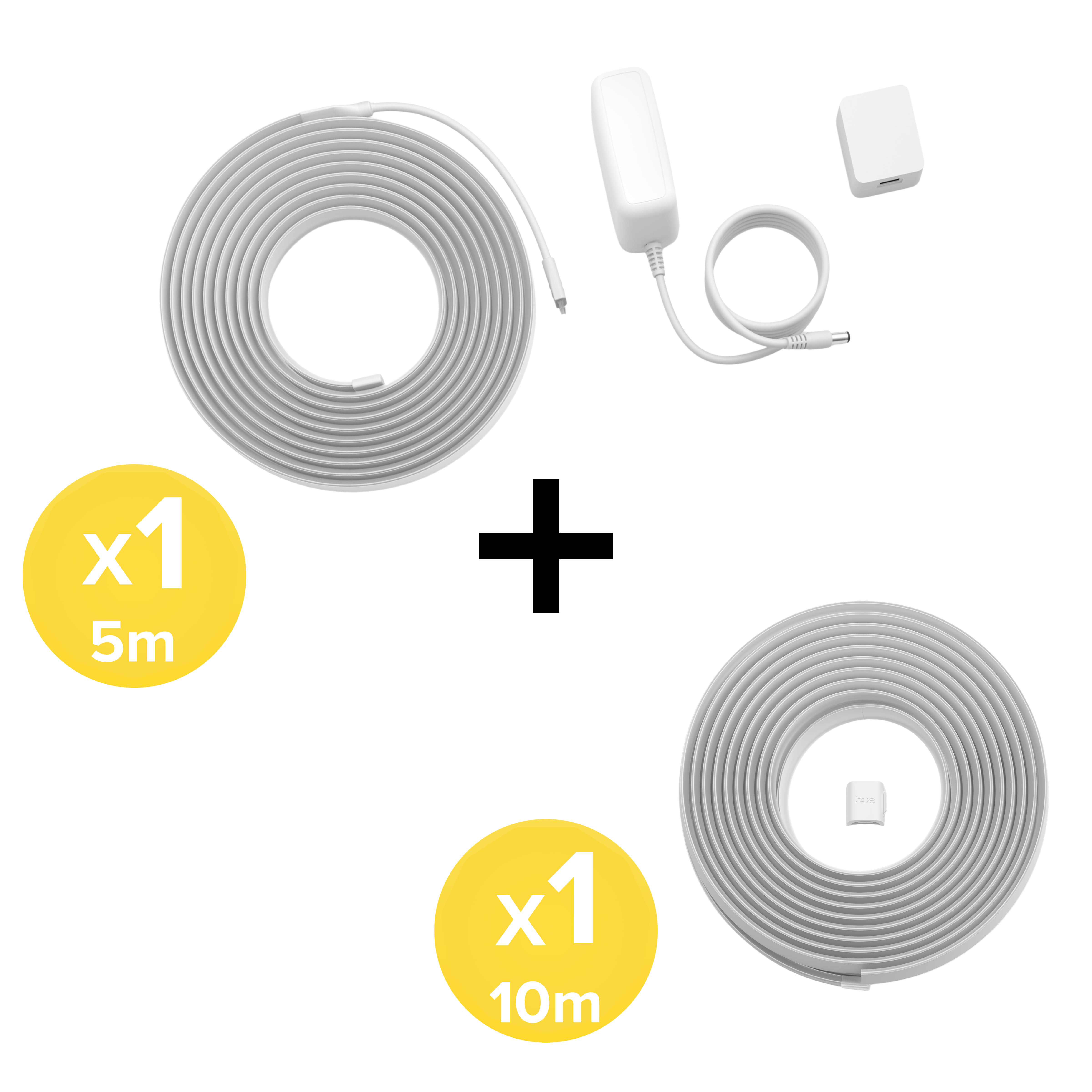 Kit di strisce LED bianche con rotoli da 5m e 10m, alimentatore e piccolo adattatore su sfondo bianco.