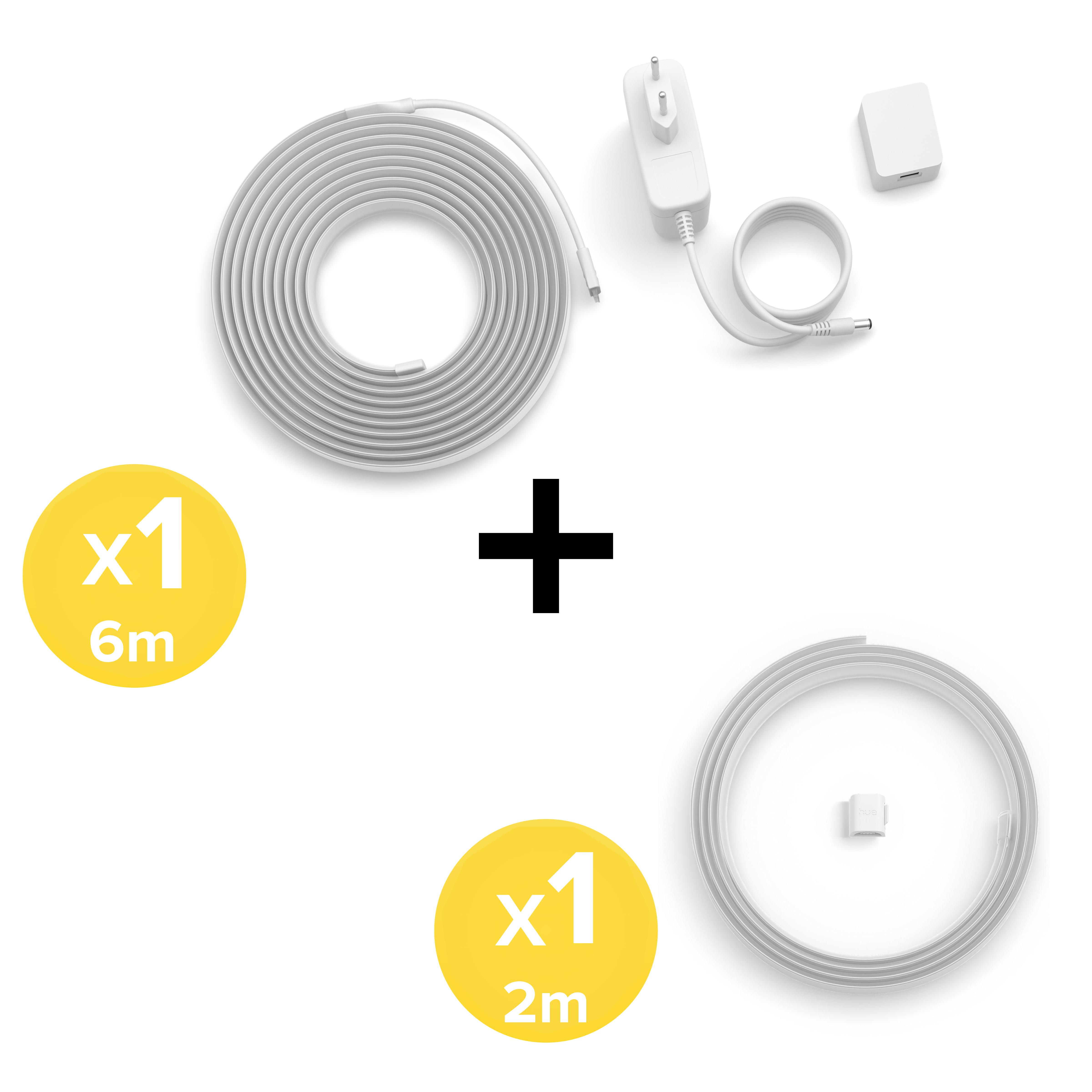 Una striscia led da 6m, una da 2m, alimentatore e spina su sfondo bianco.