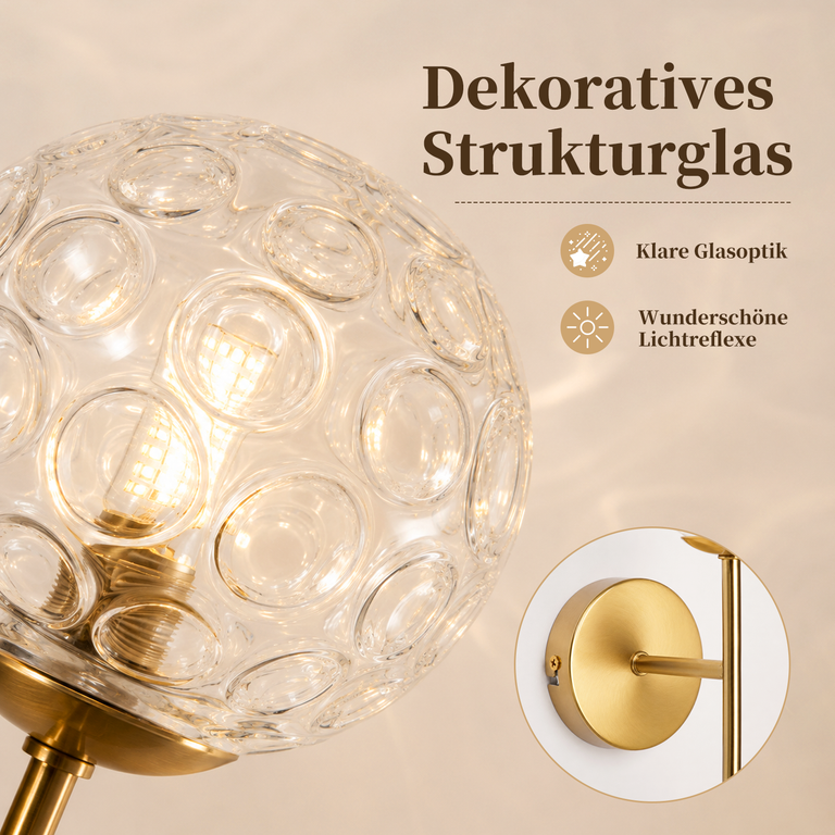 Dekorative Strukturglas-Lampe mit goldenem Sockel und klarem Licht.
