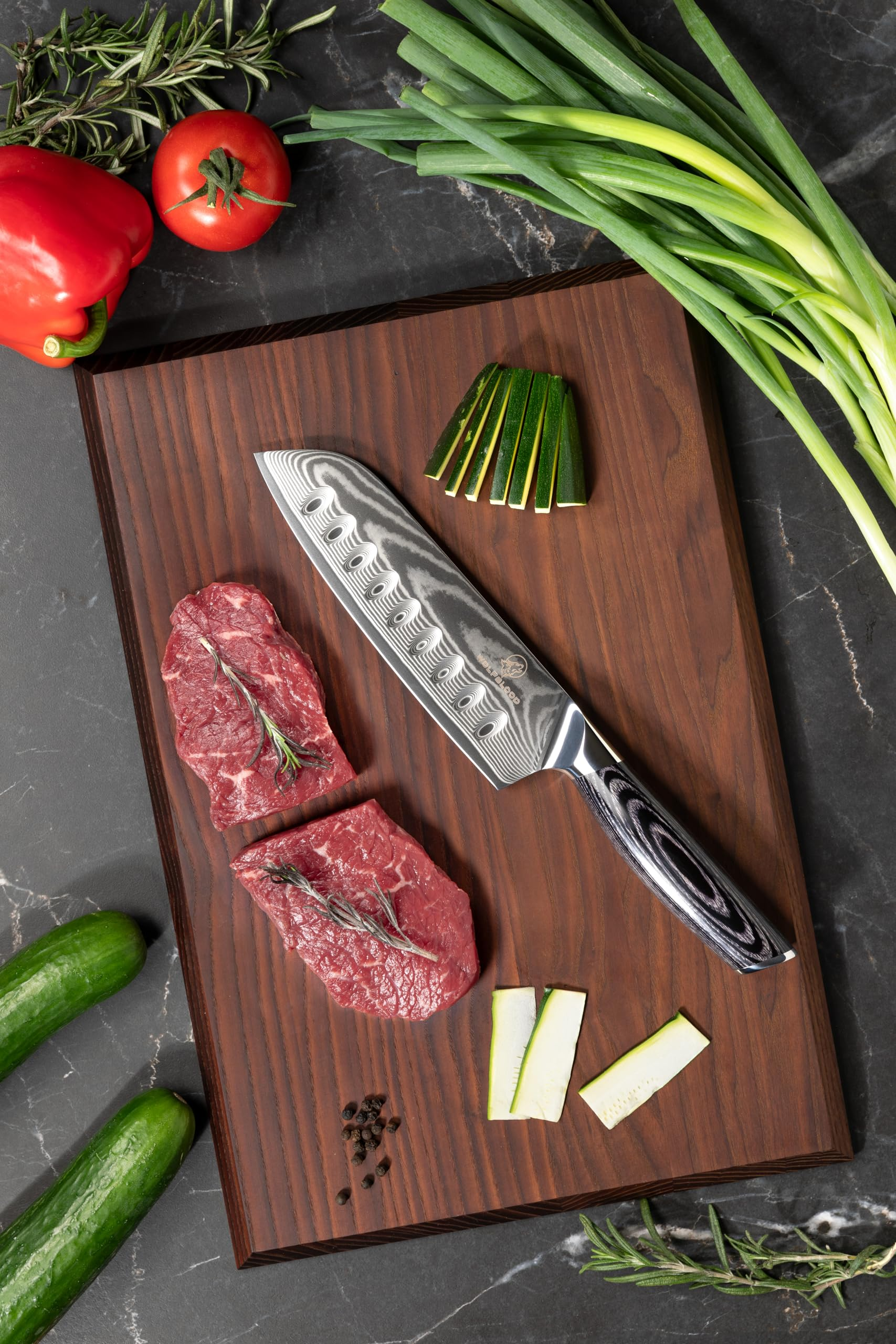 Un couteau de chef repose sur une planche en bois avec de la viande et des légumes.