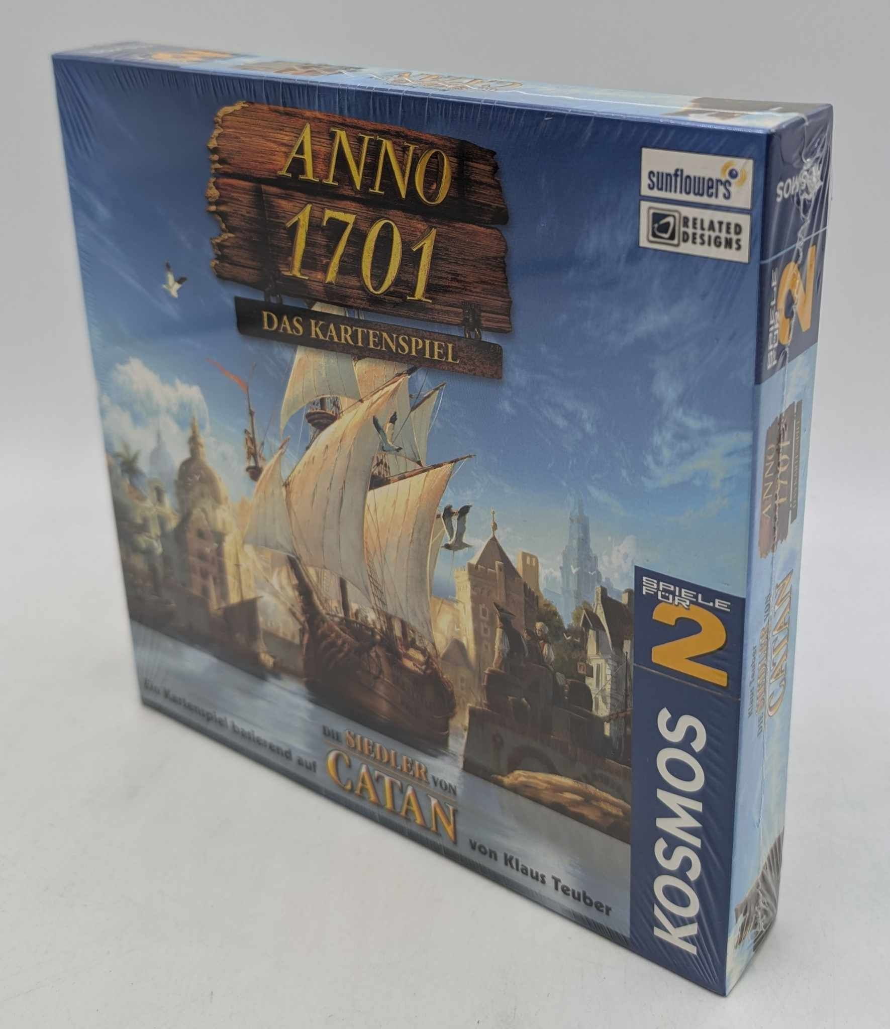 Verpackung des Kartenspiels Anno 1701 mit einem großen Segelschiff vor einer historischen Hafenstadt.