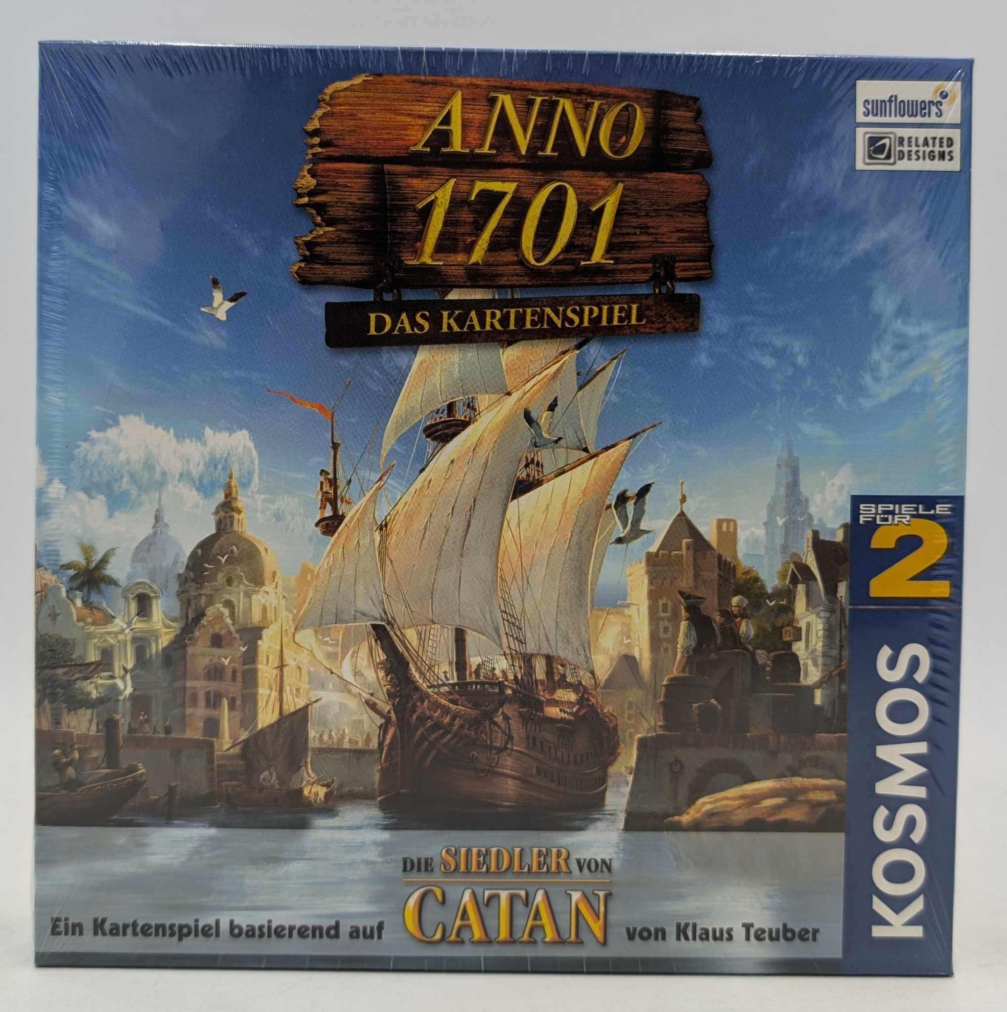 Brettspielverpackung für Anno 1701: Das Kartenspiel mit einem großen Segelschiff vor einer historischen Hafenstadt.