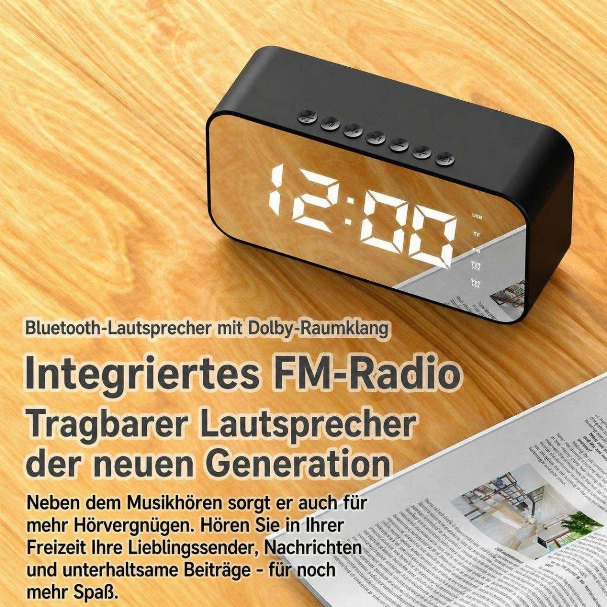 Ein schwarzer digitaler Wecker auf Zeitungspapier mit deutscher Werbung für tragbare Lautsprecher und FM-Radio.