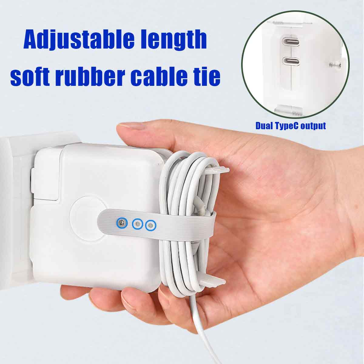 Hand hält weißes Ladegerät mit Kabel, gesichert durch einen verstellbaren weichen Gummikabelbinder.