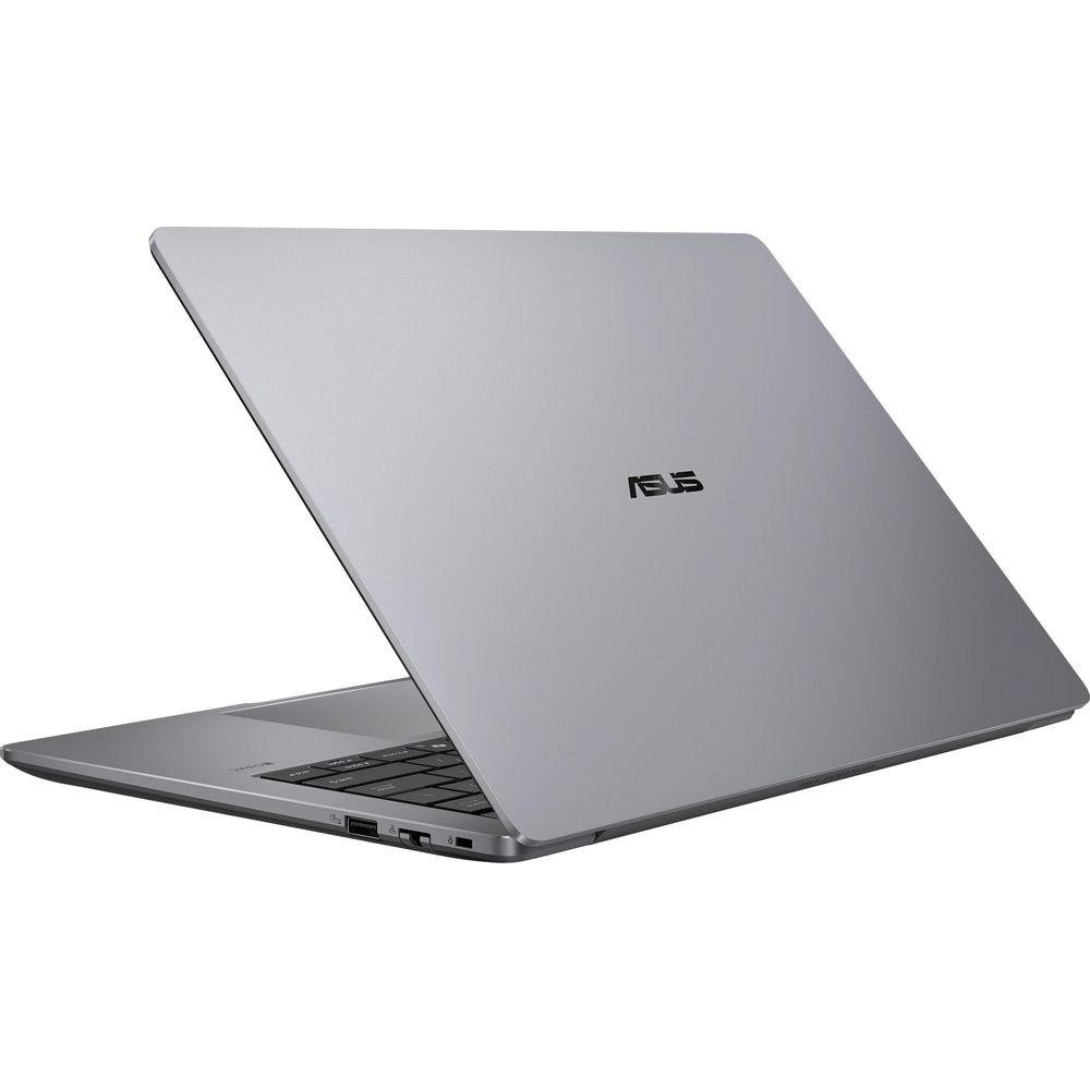 Un ordinateur portable ASUS argenté sur une surface blanche, clavier partiellement visible.