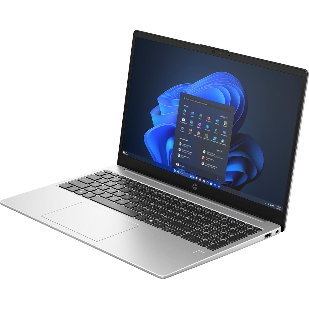 Un computer portatile argentato con tastiera nera e uno sfondo astratto blu sullo schermo.