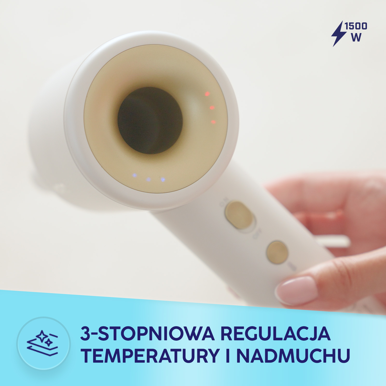 Ręka trzyma nowoczesną biało-złotą suszarkę 1500W z regulacją temperatury.