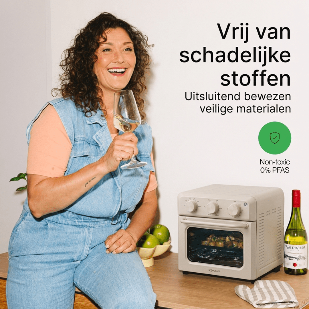 Happy woman with wine glass beside a beige oven and text on white background.