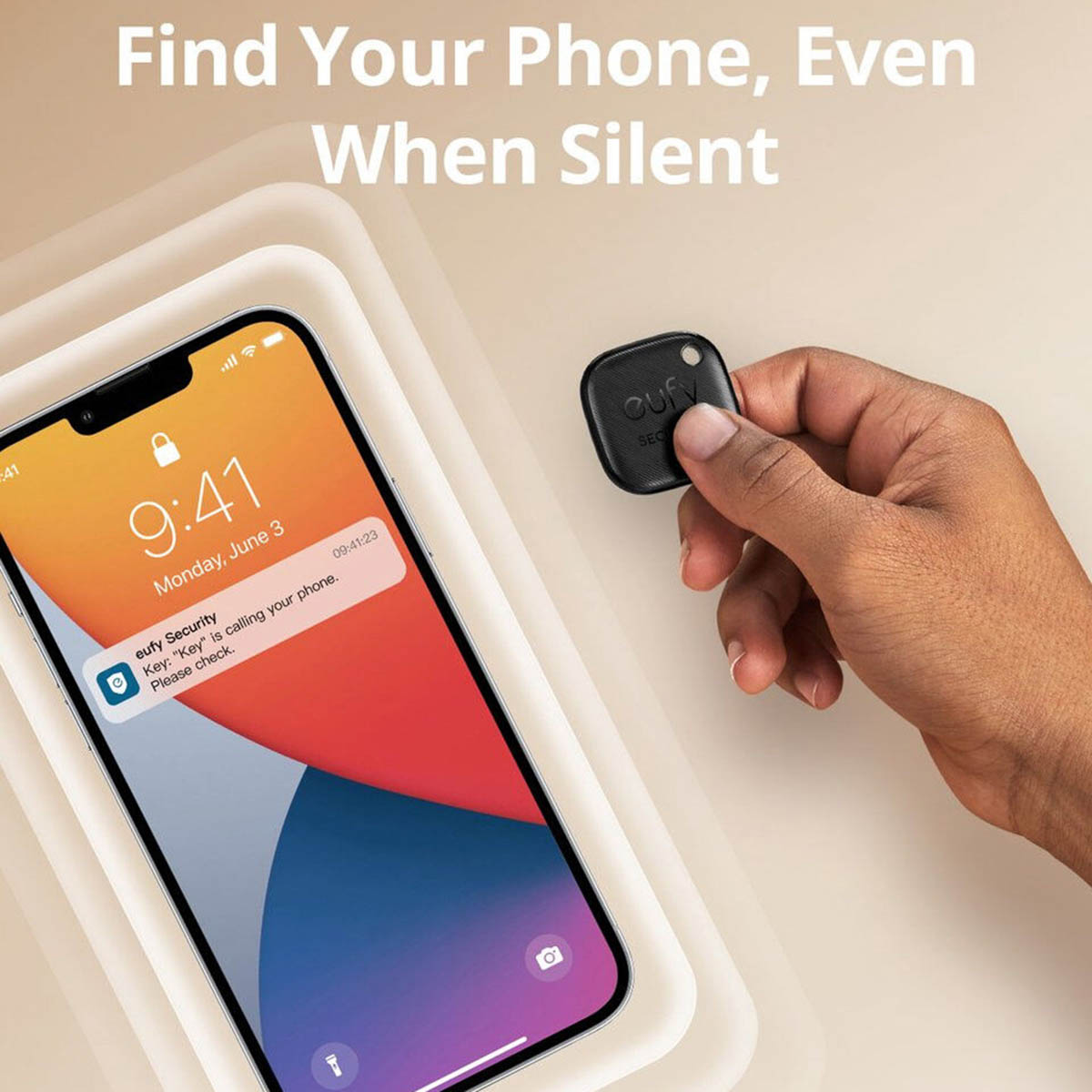 Hand holds a small black eufy tracker while a smartphone displays an app notification.