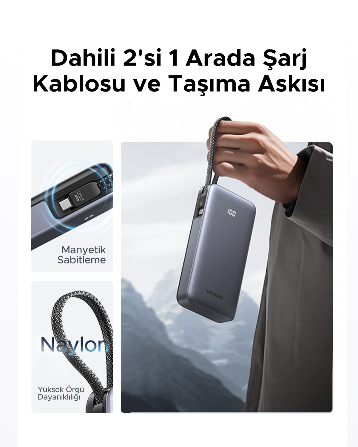 Szary powerbank z paskiem i wbudowanym kablem trzymany w ręku, na tle gór.