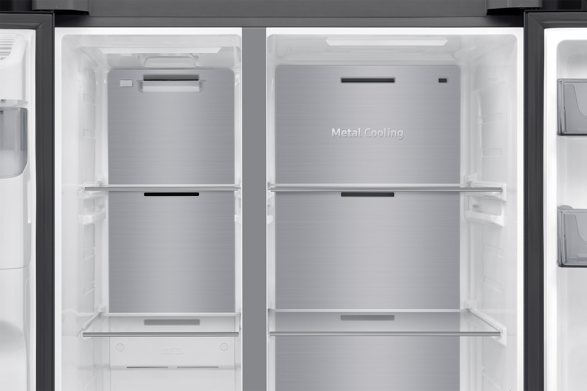 Open refrigerator interior with metal cooling panels and glass shelves.