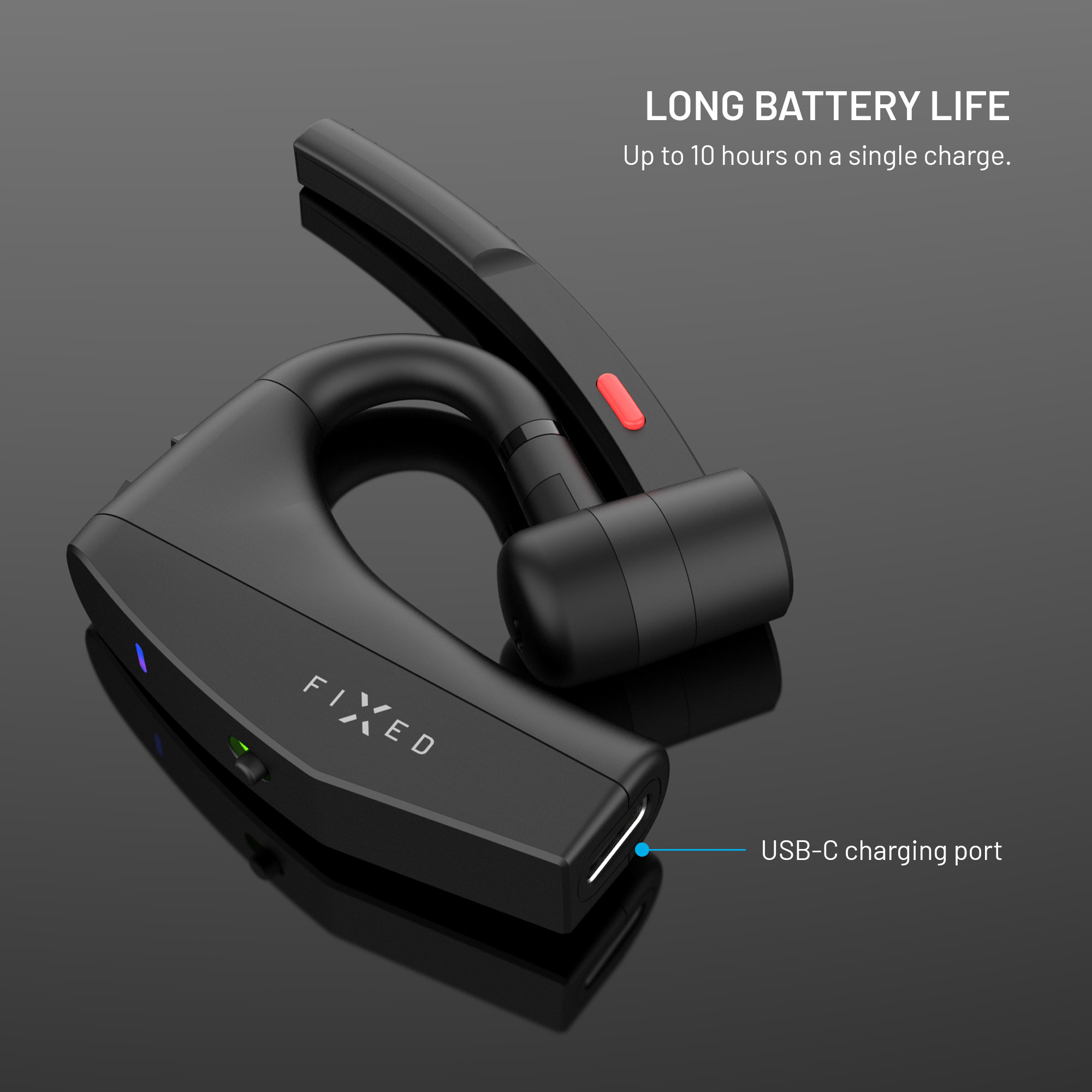 Schwarzes FIXED Bluetooth-Headset auf glänzender Oberfläche mit USB-C-Anschluss.