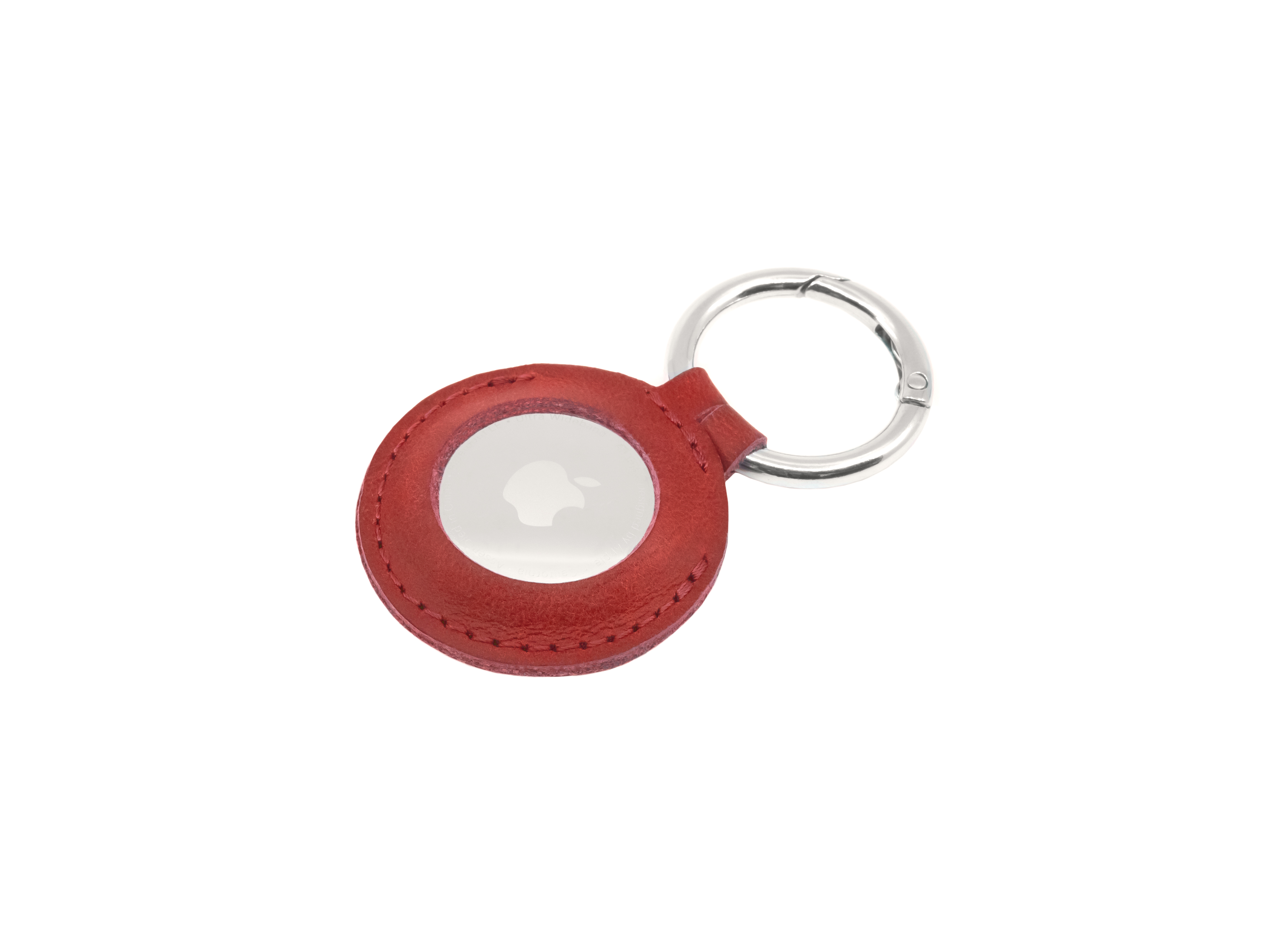 Ein roter Lederanhänger mit silbernem Ring und Apple AirTag in der Mitte.