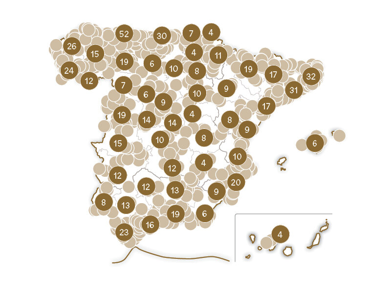 Mapa de España cubierto de círculos marrones numerados que indican varias regiones y valores.
