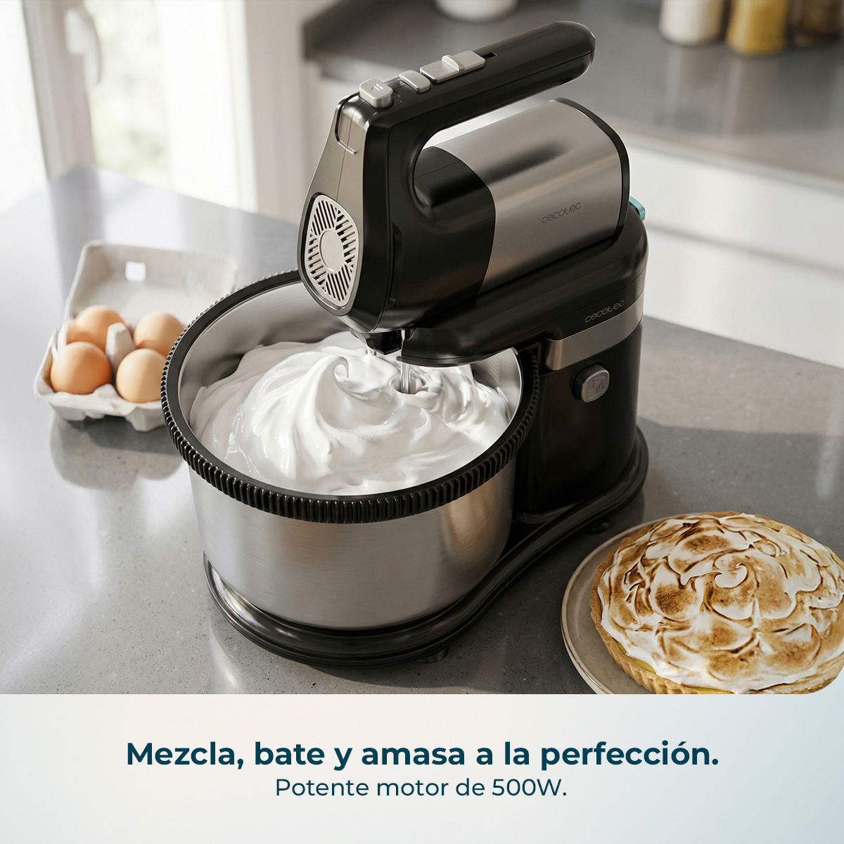 Una batidora plateada y negra mezcla masa en un bol de metal. Huevos y un pastel están cerca.