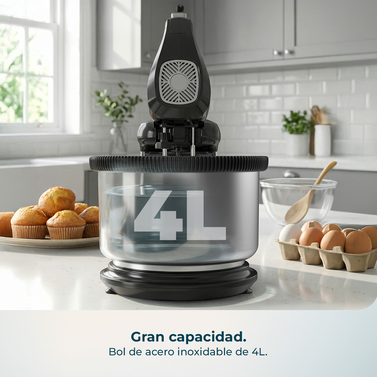 Batidora de mano negra sobre bol de acero inoxidable de 4 litros en cocina con magdalenas y huevos.