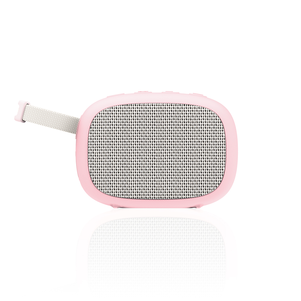 Przenośny różowy głośnik Bluetooth z białą, materiałową przednią częścią i szarym paskiem na białym tle.