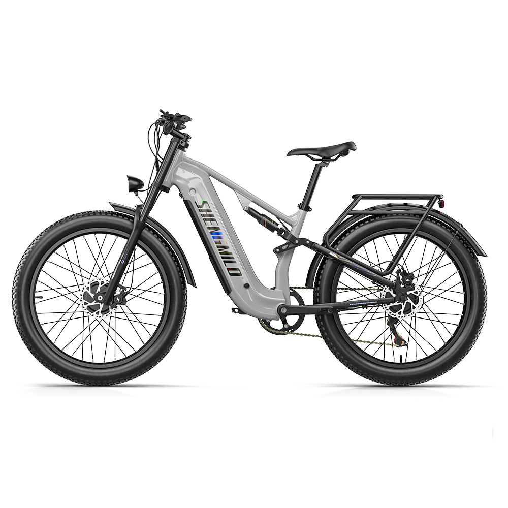 Bicicleta eléctrica de montaña gris Shengmilo con neumáticos anchos y portaequipajes trasero.
