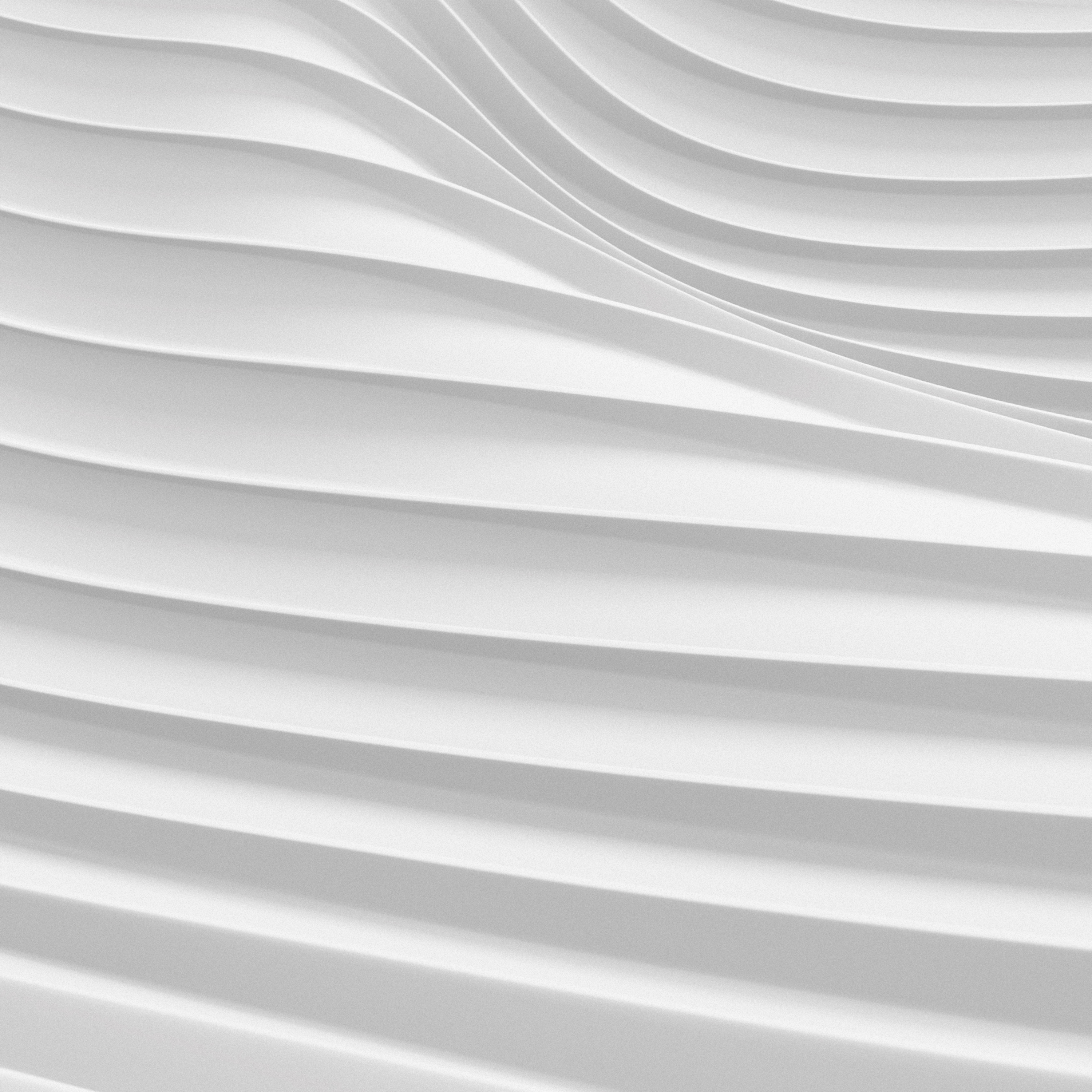 Abstrakte weiße Oberfläche mit geschwungenen, parallelen Linien und Schatten.