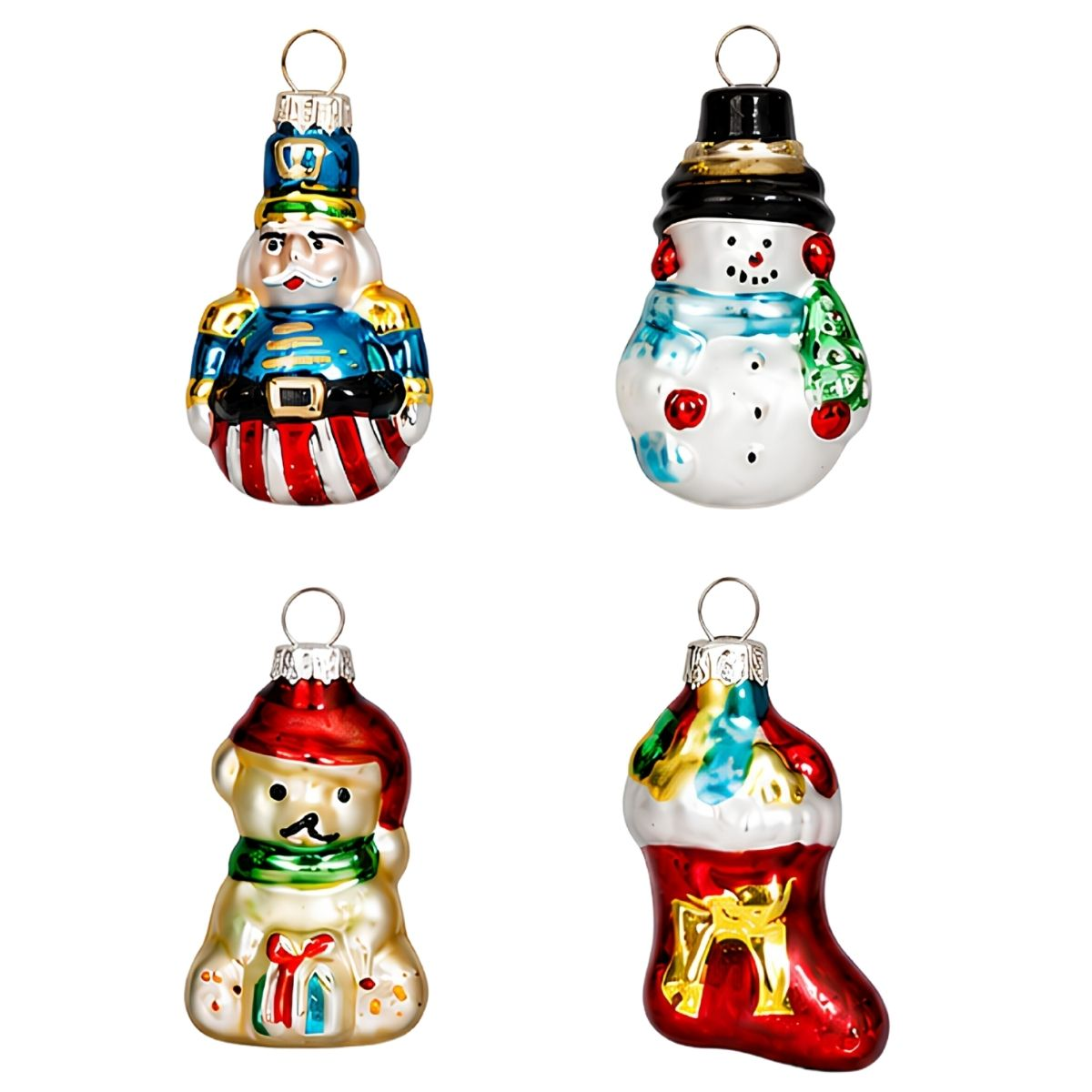 Four colorful glass Christmas tree ornaments shaped like a nutcracker, snowman, bear, and stocking on white.