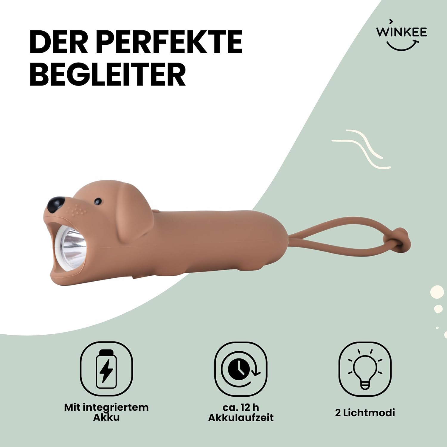 Eine braune hundeförmige Taschenlampe mit hellem Licht im Maul und einer Schlaufe vor grünem Hintergrund.