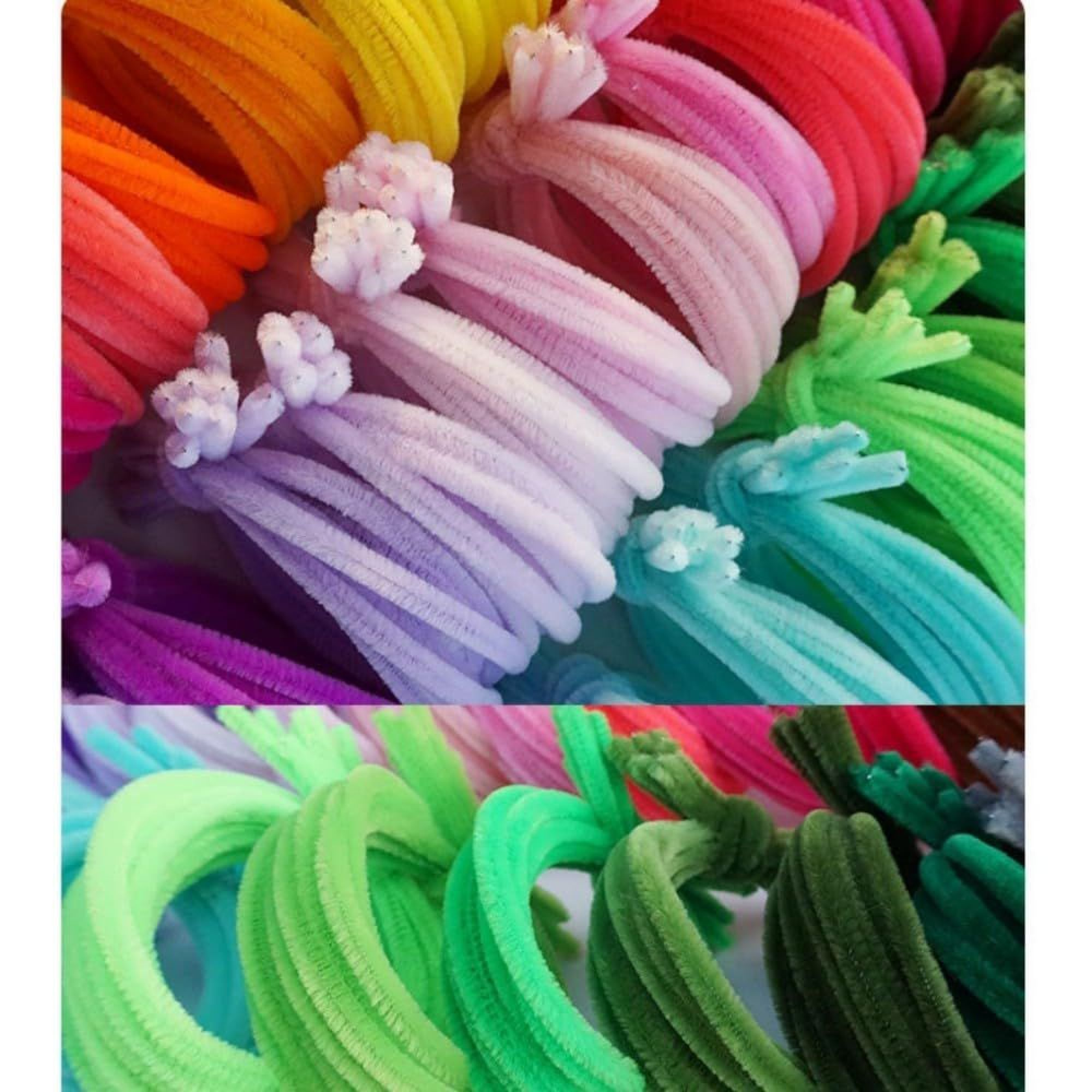 Bunte flauschige Pfeifenreiniger in Regenbogenfarben angeordnet.
