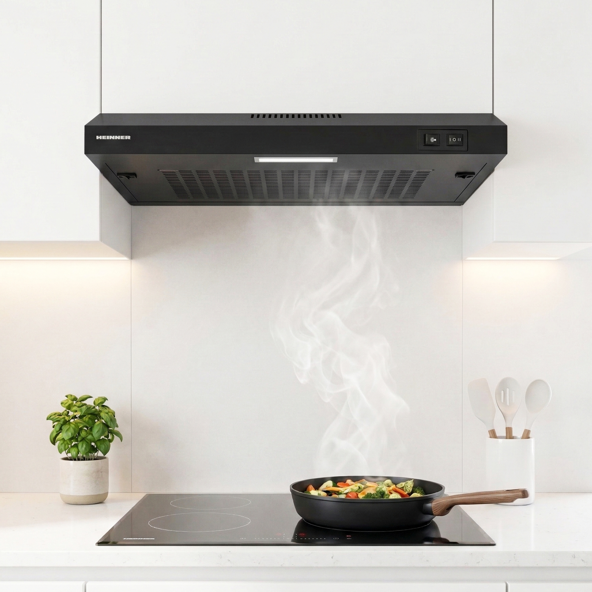 Une hotte aspirante noire au-dessus d'une plaque de cuisson avec des légumes fumants.