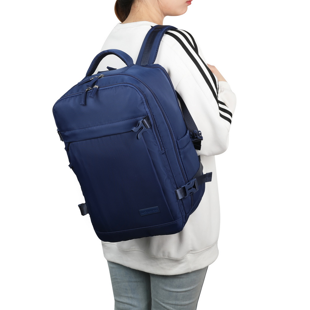 Una persona lleva una mochila azul grande en la espalda sobre un fondo blanco.