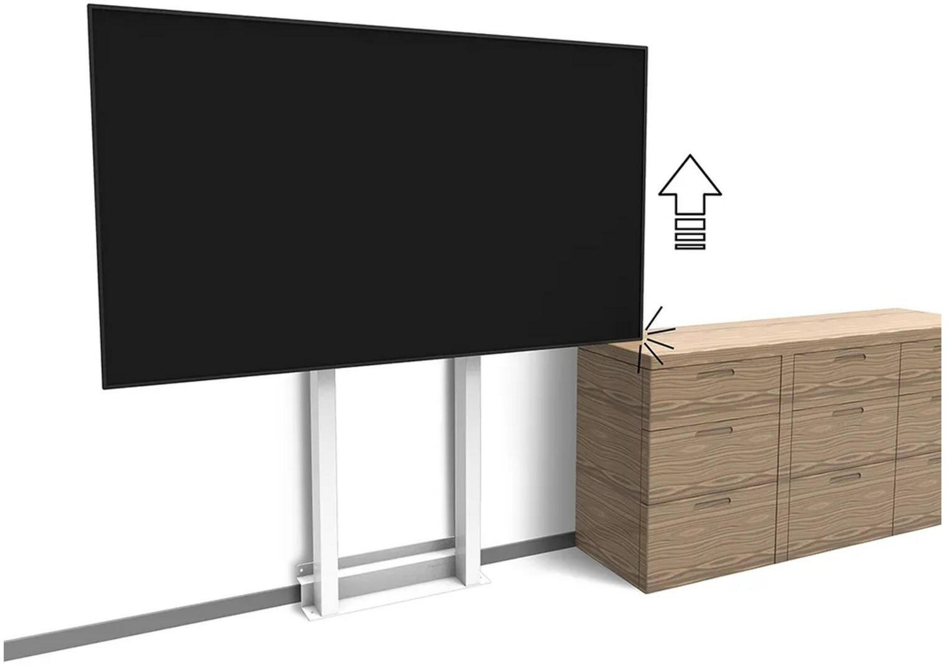 Un gran televisor negro en un soporte blanco junto a una cómoda de madera, con una flecha hacia arriba.
