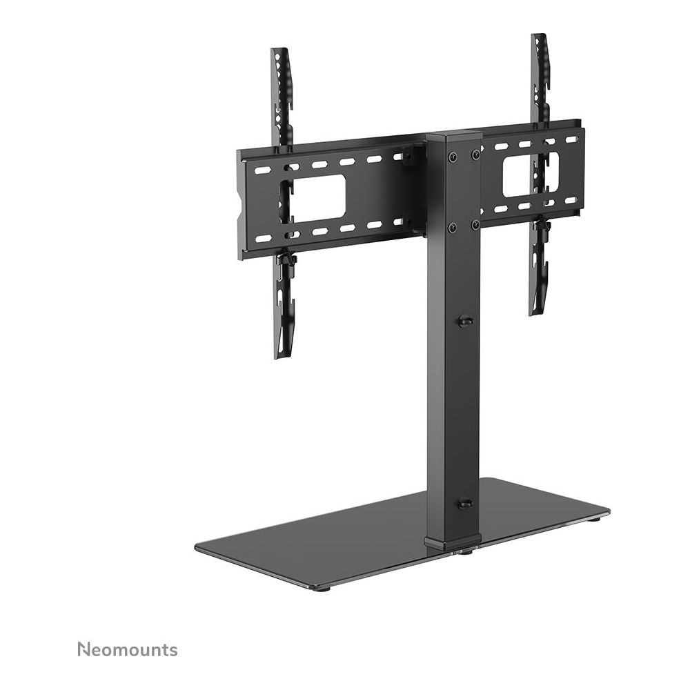 Supporto TV da tavolo nero con colonna verticale, base piatta e staffe di montaggio regolabili su sfondo bianco.