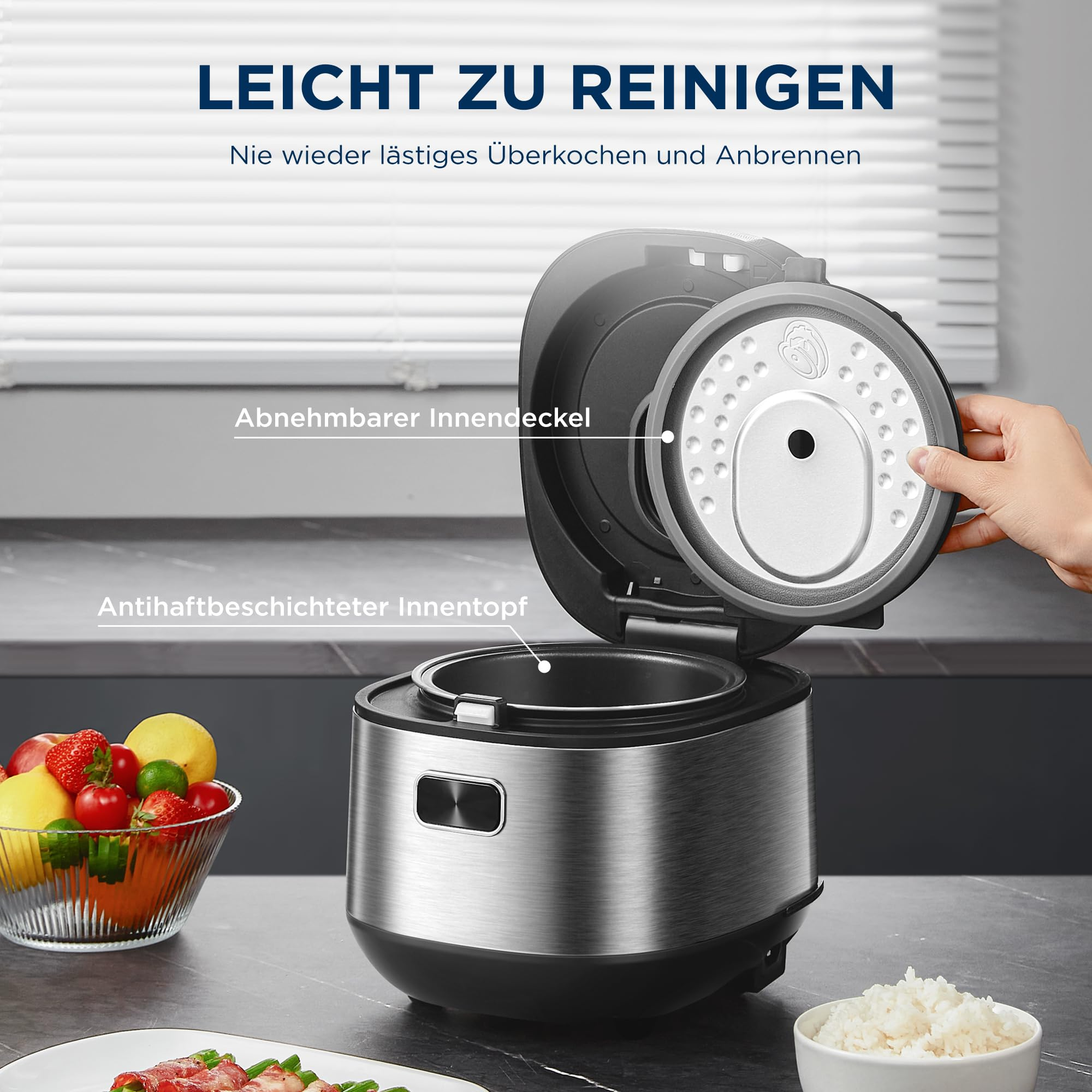 Edelstahl-Reiskocher mit abnehmbarem Innendeckel und antihaftbeschichtetem Innentopf auf einer Küchentheke.