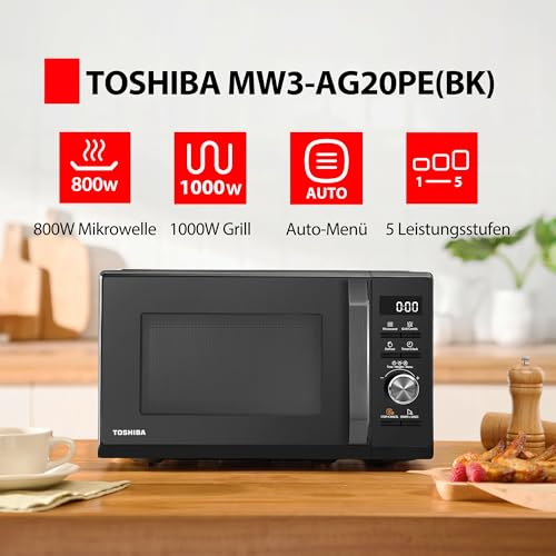 Micro-ondes noir Toshiba sur une table en bois avec des icônes de fonctionnalités.