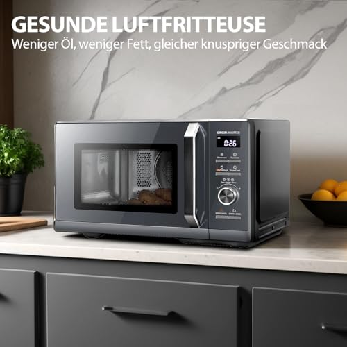 Un micro-ondes friteuse à air noir sur un plan de travail blanc.