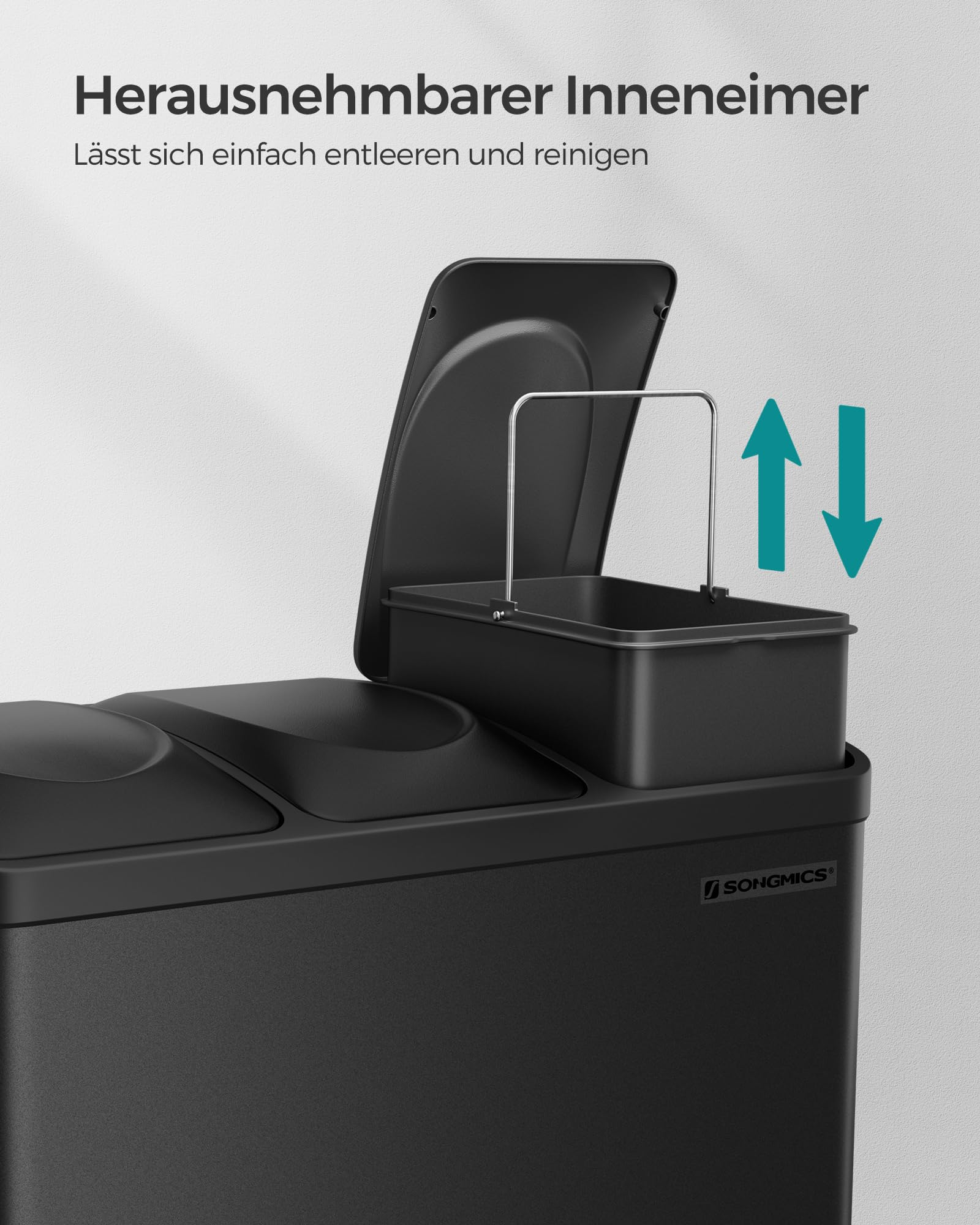 Ein schwarzer Mülleimer mit einem herausnehmbaren Inneneimer und Metallgriff vor einer grauen Wand.