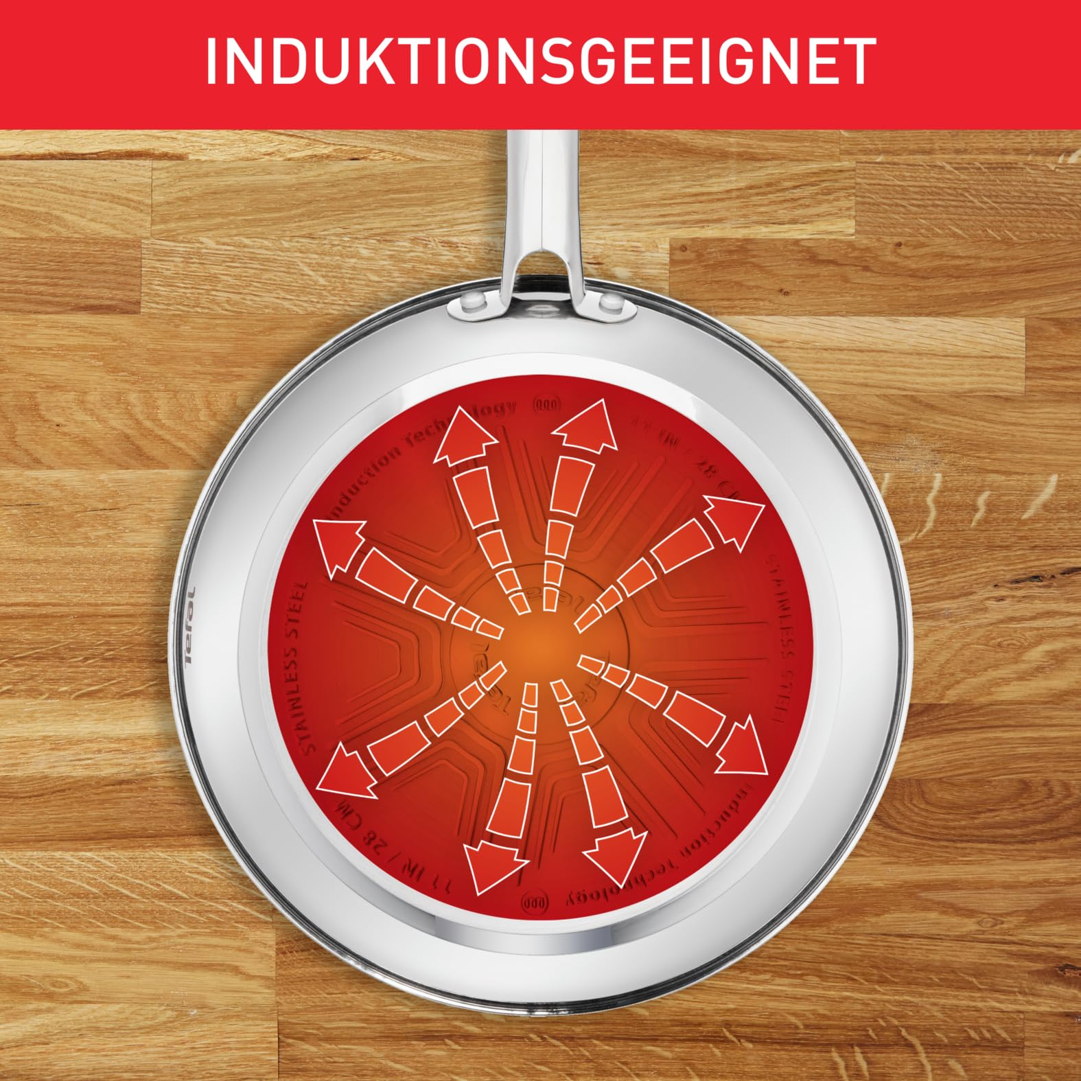 Poelle en inox avec fond a induction rouge sur bois.