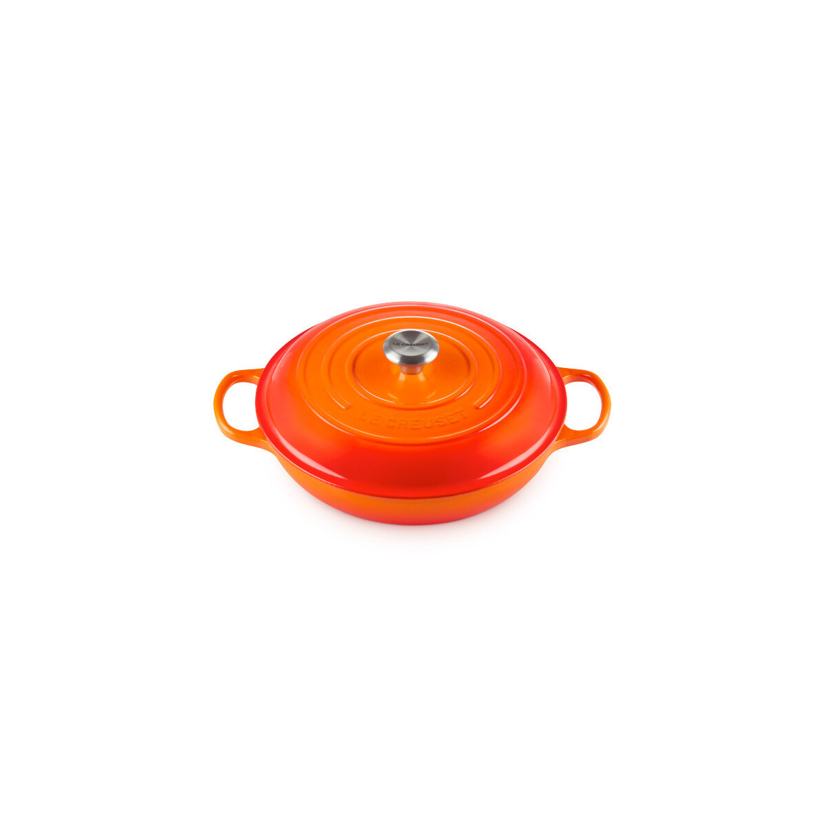 Une cocotte basse en fonte orange avec un couvercle et un bouton argenté sur fond blanc.