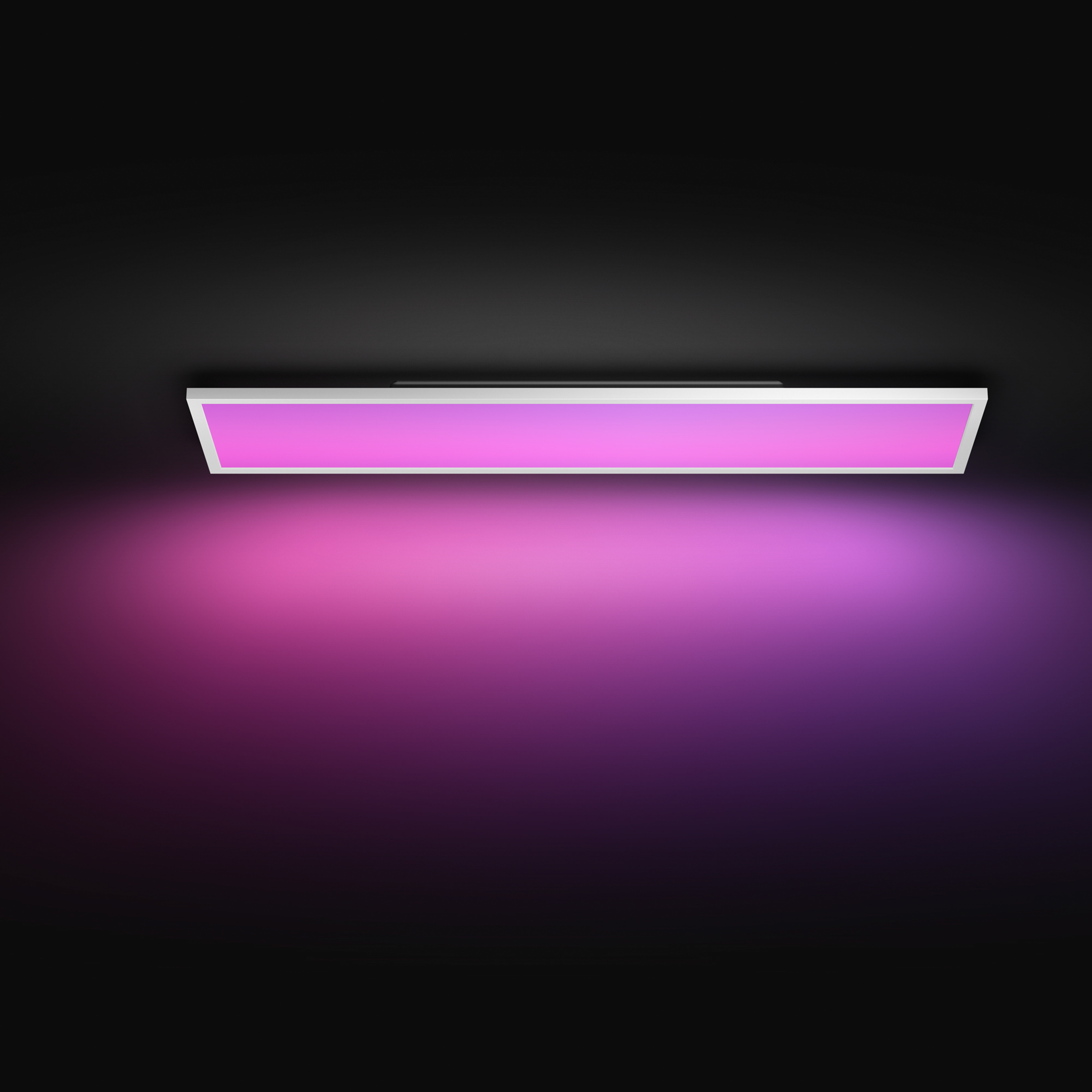 Una plafoniera rettangolare bianca emette una vivace luce rosa e viola su sfondo scuro.
