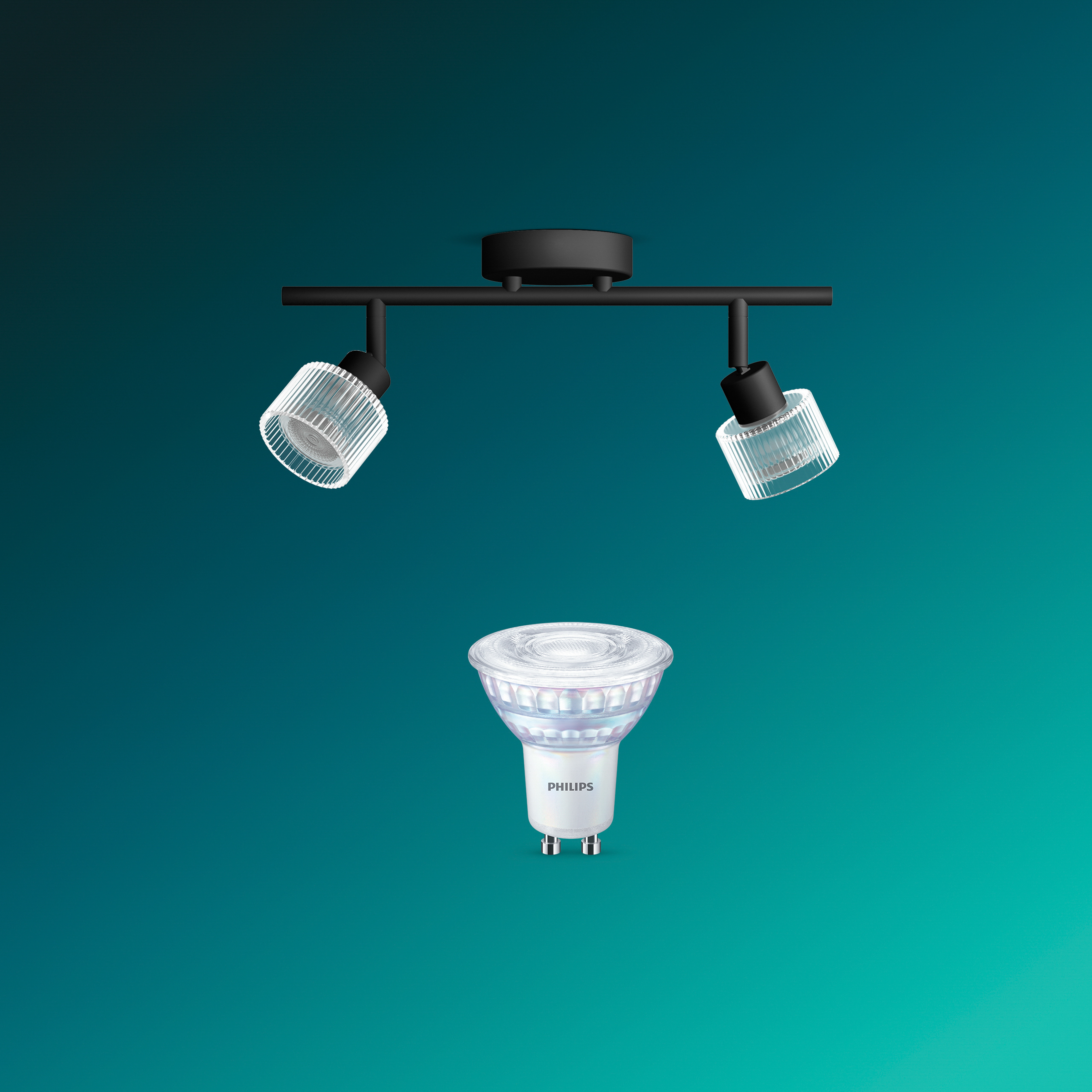 Eine schwarze Deckenleuchte mit zwei gerippten Glasschirmen und einer Philips LED-Lampe darunter auf türkisem Grund.