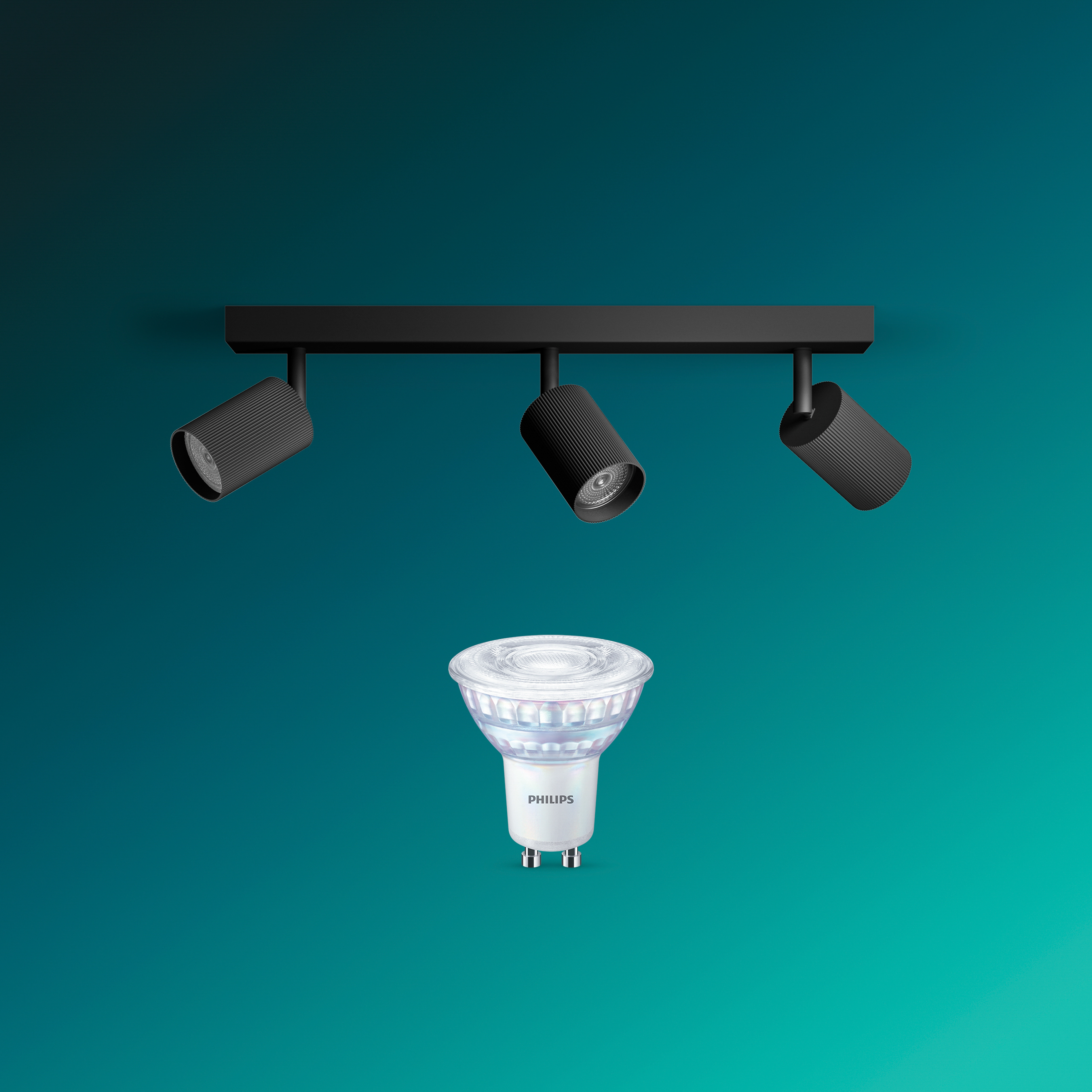 Drei schwarze Deckenspots und eine Philips LED-Glühbirne vor blauem Hintergrund.