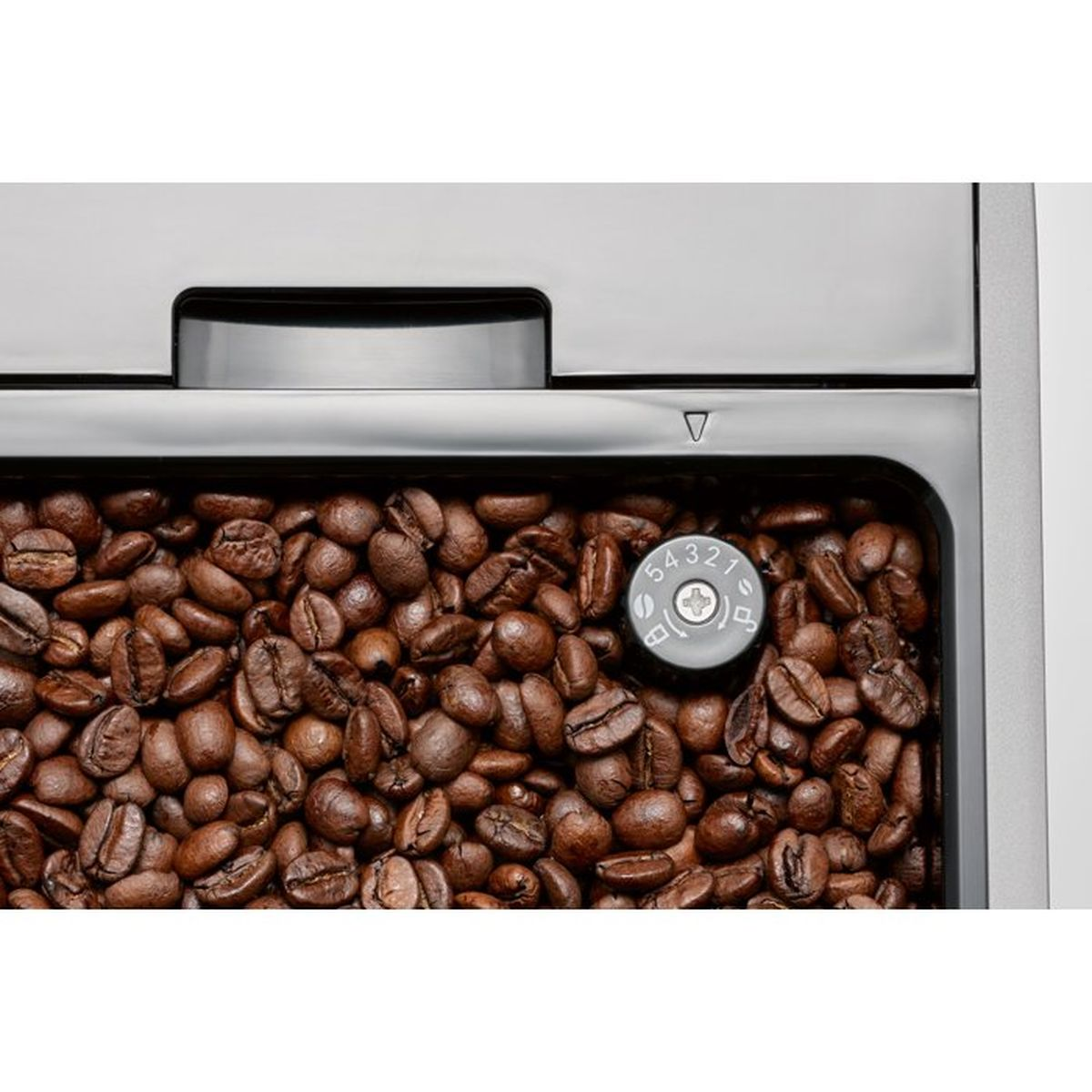Chicchi di caffè nel contenitore di una macchina con manopola di regolazione.