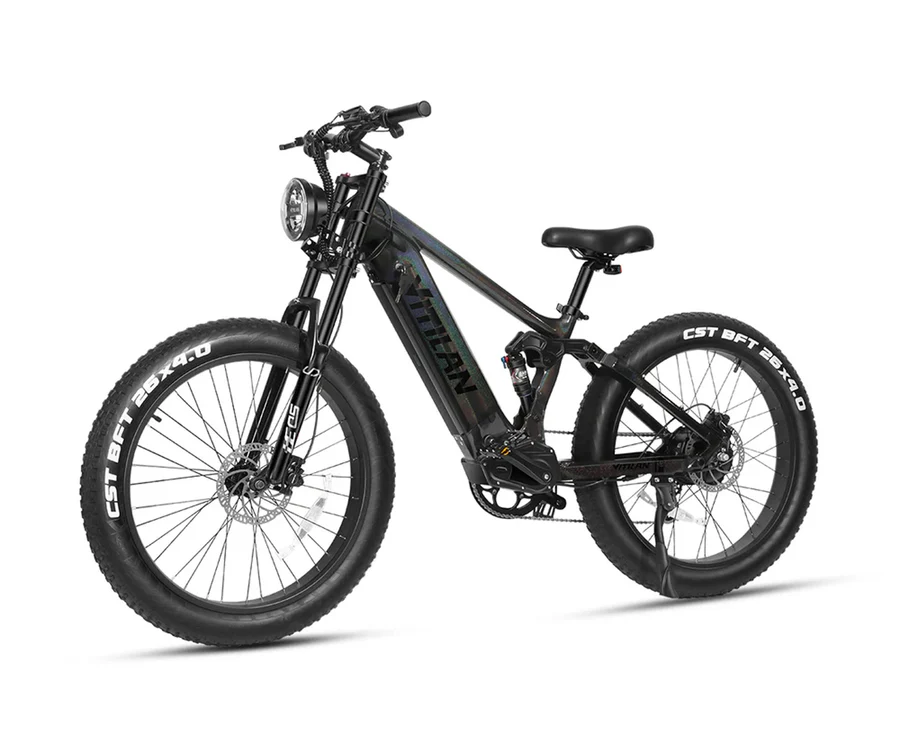 Una mountain bike elettrica nera con pneumatici larghi, faro e forcella ammortizzata su sfondo bianco.