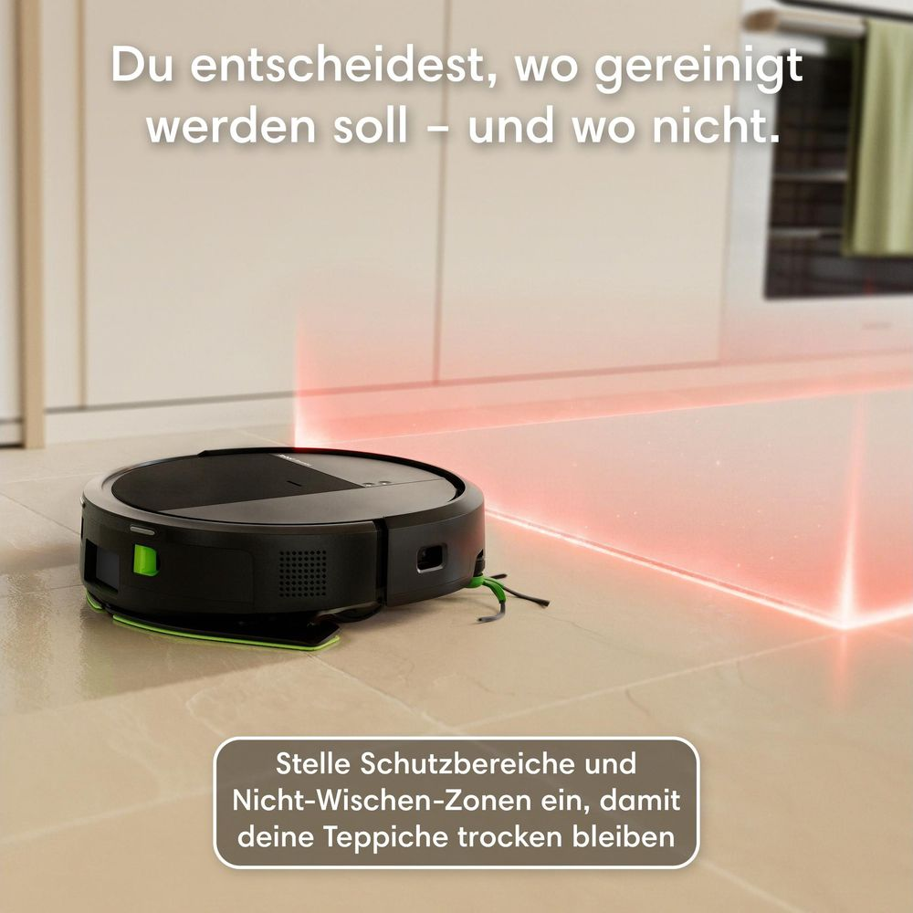 Un robot aspirapolvere nero proietta un fascio di luce rossa sul pavimento per segnare le aree protette.