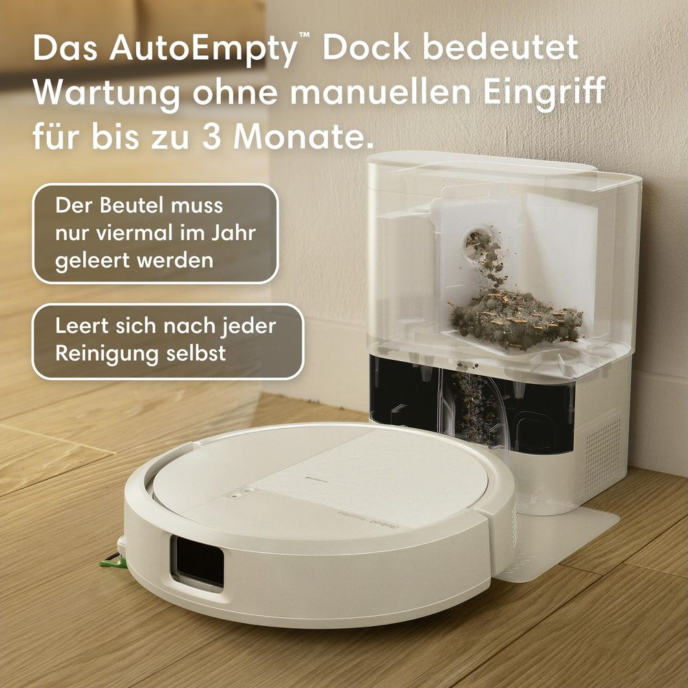 Un robot aspirateur blanc se gare devant sa station de vidage automatique sur un sol en bois.