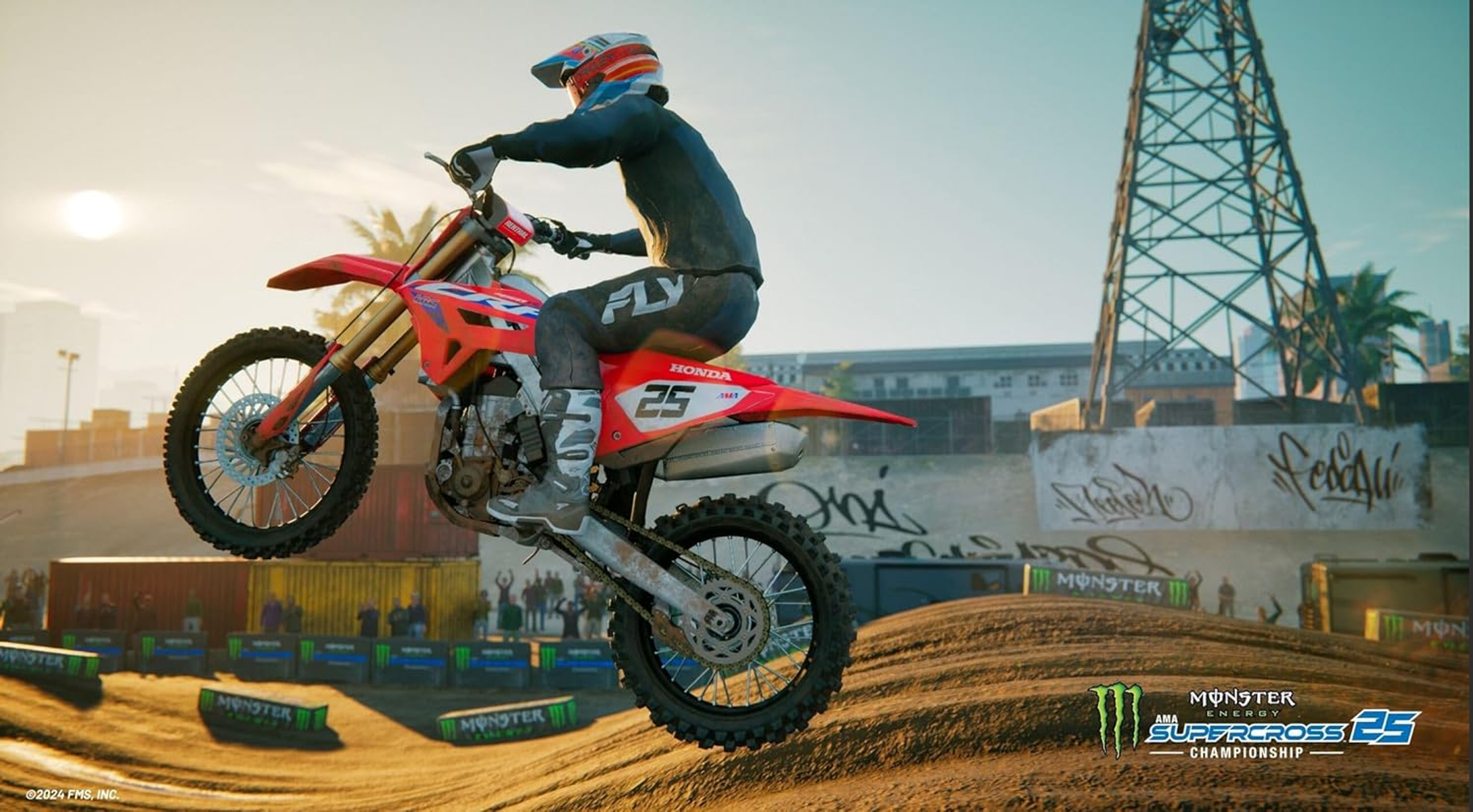 Un motociclista de motocross con equipo completo salta una moto Honda roja en una pista de tierra al atardecer.