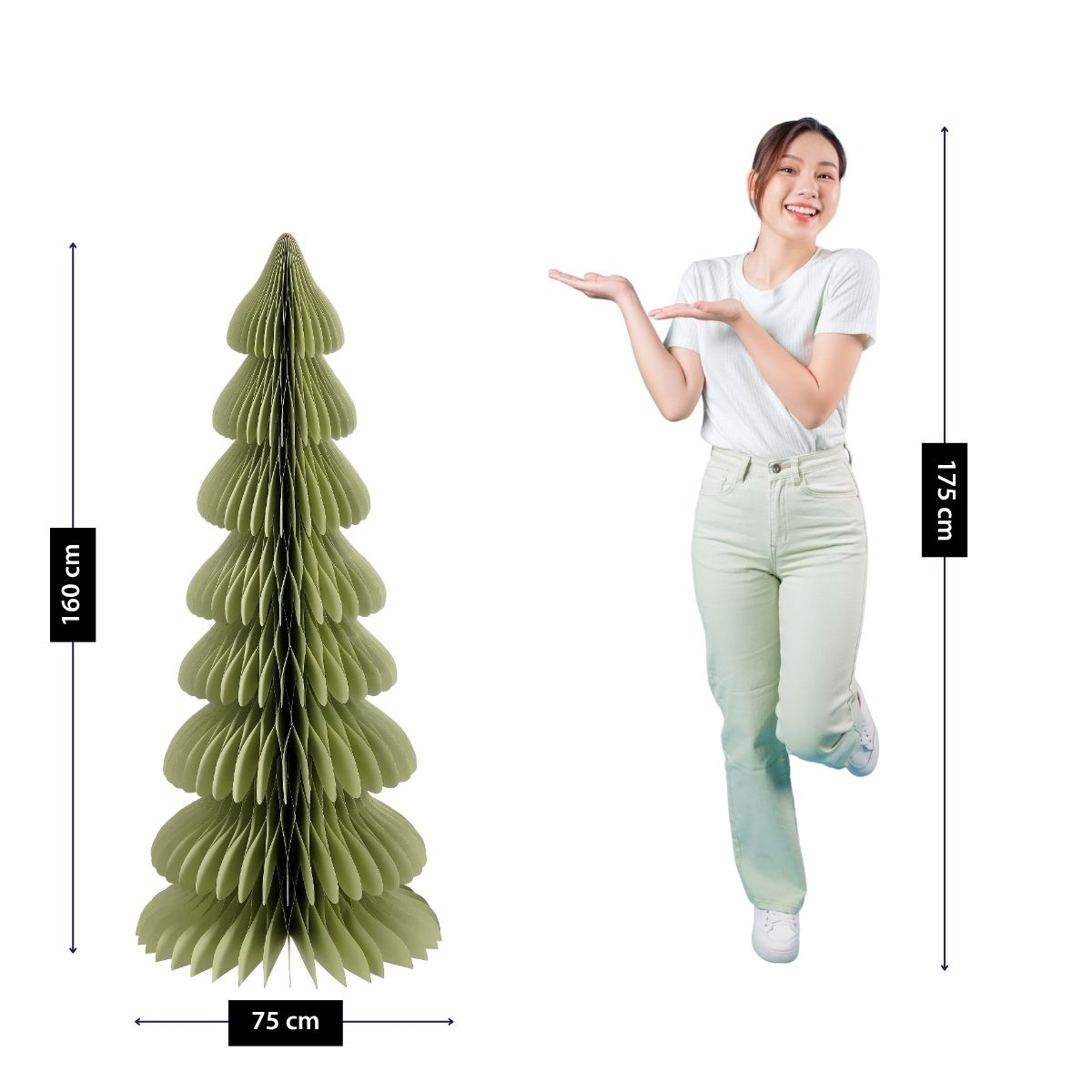 A woman points to a large green paper Christmas tree with dimensions 160x75 cm.