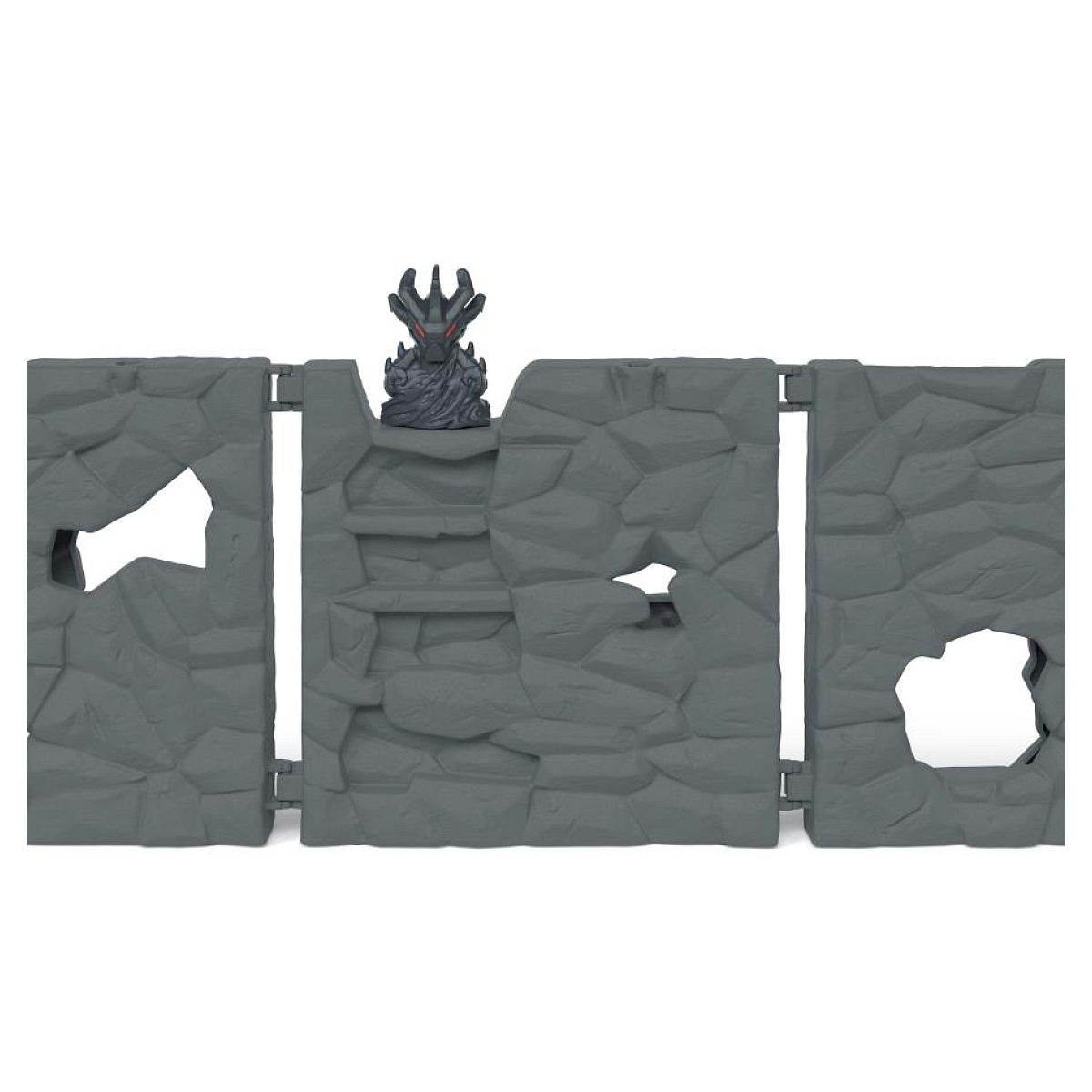 Paredes de piedra de juguete de plástico gris con agujeros y una figura de monstruo con cuernos encima.