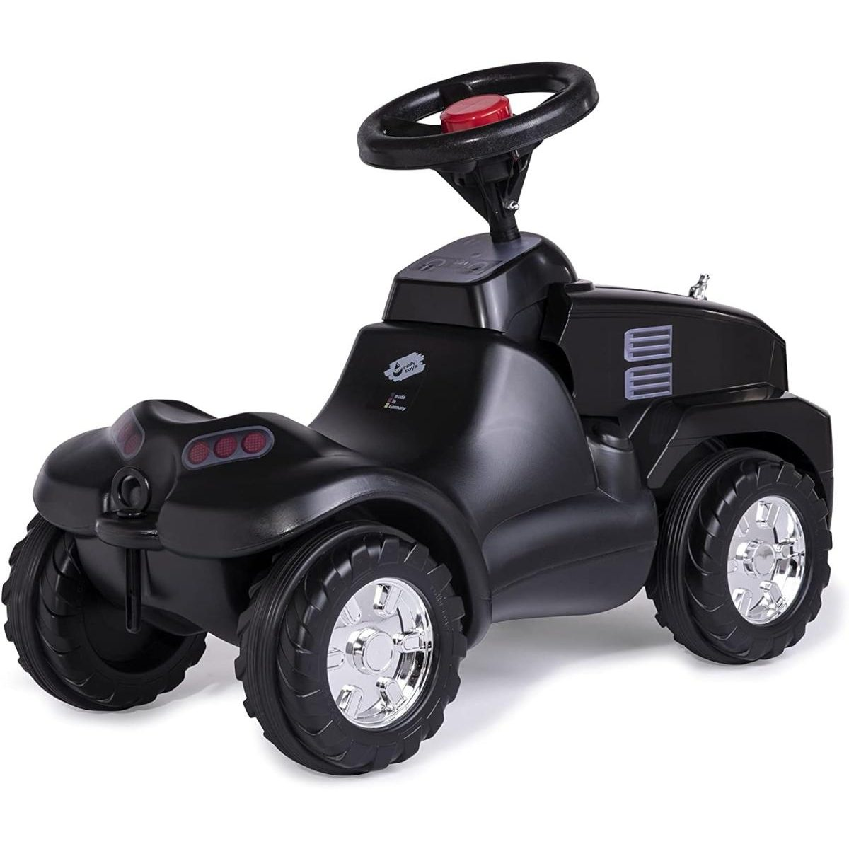 Ein schwarzes Kinderspielszeugauto mit silbernen Felgen, einem großen Lenkrad und einem roten Hornknopf auf weißem Grund.